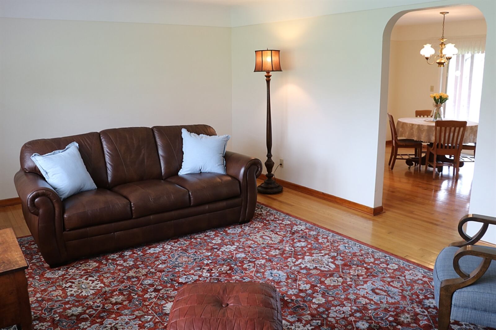 A coved ceiling adds spaciousness to the living room and matches the curved corners of the threshold into the formal dining room.