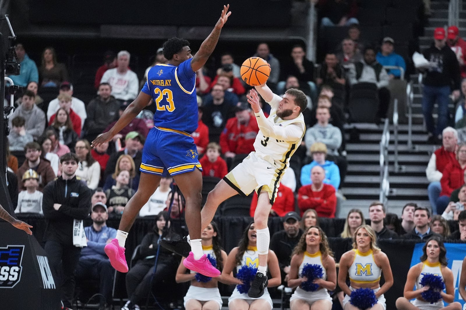 Purdue guard Braden Smith (3) passes the ball while covered by McNeese State guard Brandon Murray (23) during the first half in the second round of the NCAA college basketball tournament, Saturday, March 22, 2025, in Providence, R.I. (AP Photo/Charles Krupa)