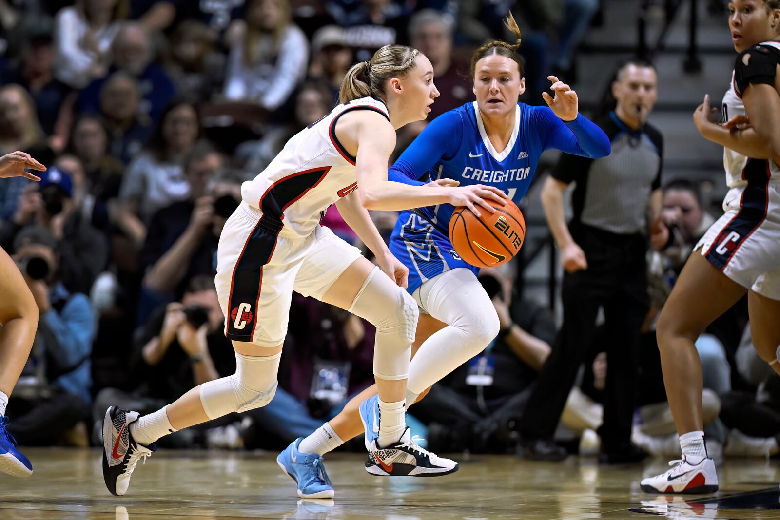 UConn guard Paige Bueckers, center left, dribbles as Creighton guard Molly Mogensen, center right, defends during the first half of an NCAA college basketball game in the finals of the Big East Conference tournament, Monday, March 10, 2025, in Uncasville, Conn. (AP Photo/Jessica Hill)