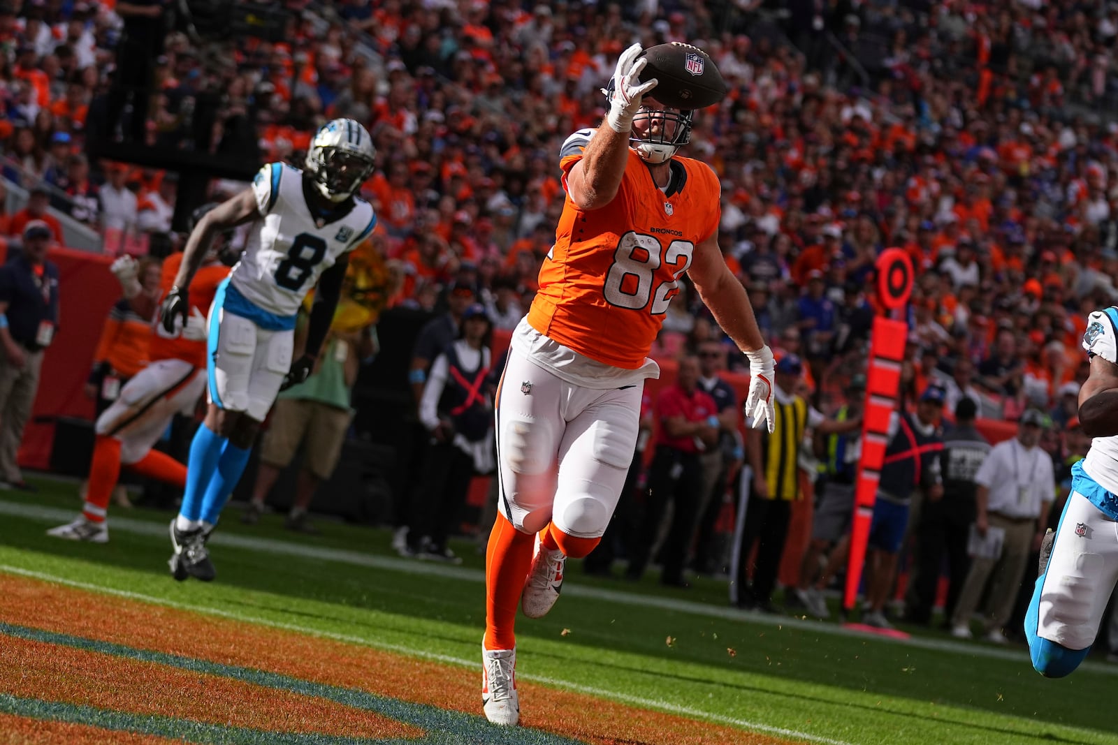 Denver Broncos tight end Adam Trautman (82) catches a pass for a touchdown against the Carolina Panthers during the first half of an NFL football game Sunday, Oct. 27, 2024, in Denver. (AP Photo/Bart Young)