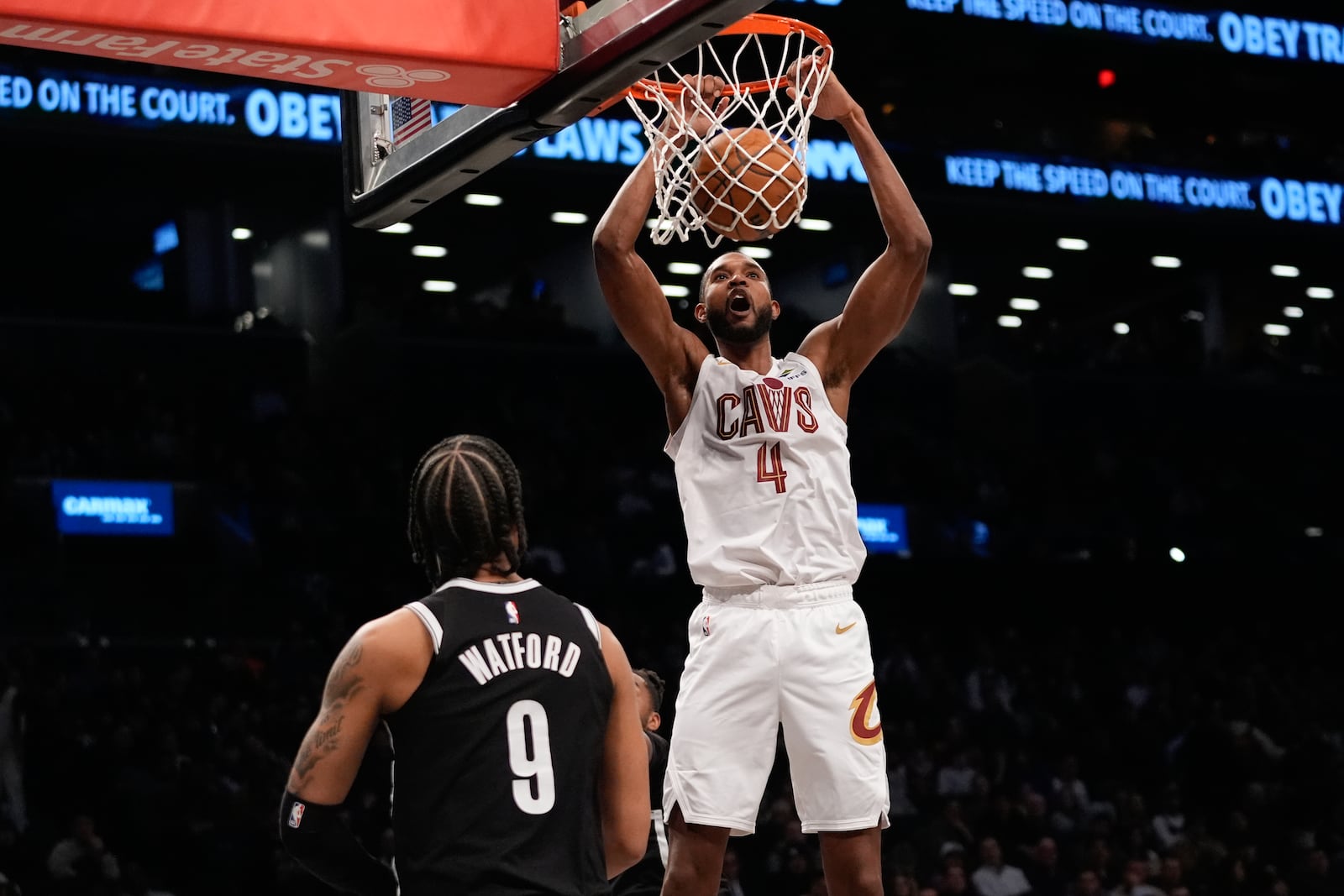 Cleveland Cavaliers' Evan Mobley (4) dunks the ball in front of Brooklyn Nets' Trendon Watford (9) during the first half of an NBA basketball game Thursday, Feb. 20, 2025, in New York. (AP Photo/Frank Franklin II)