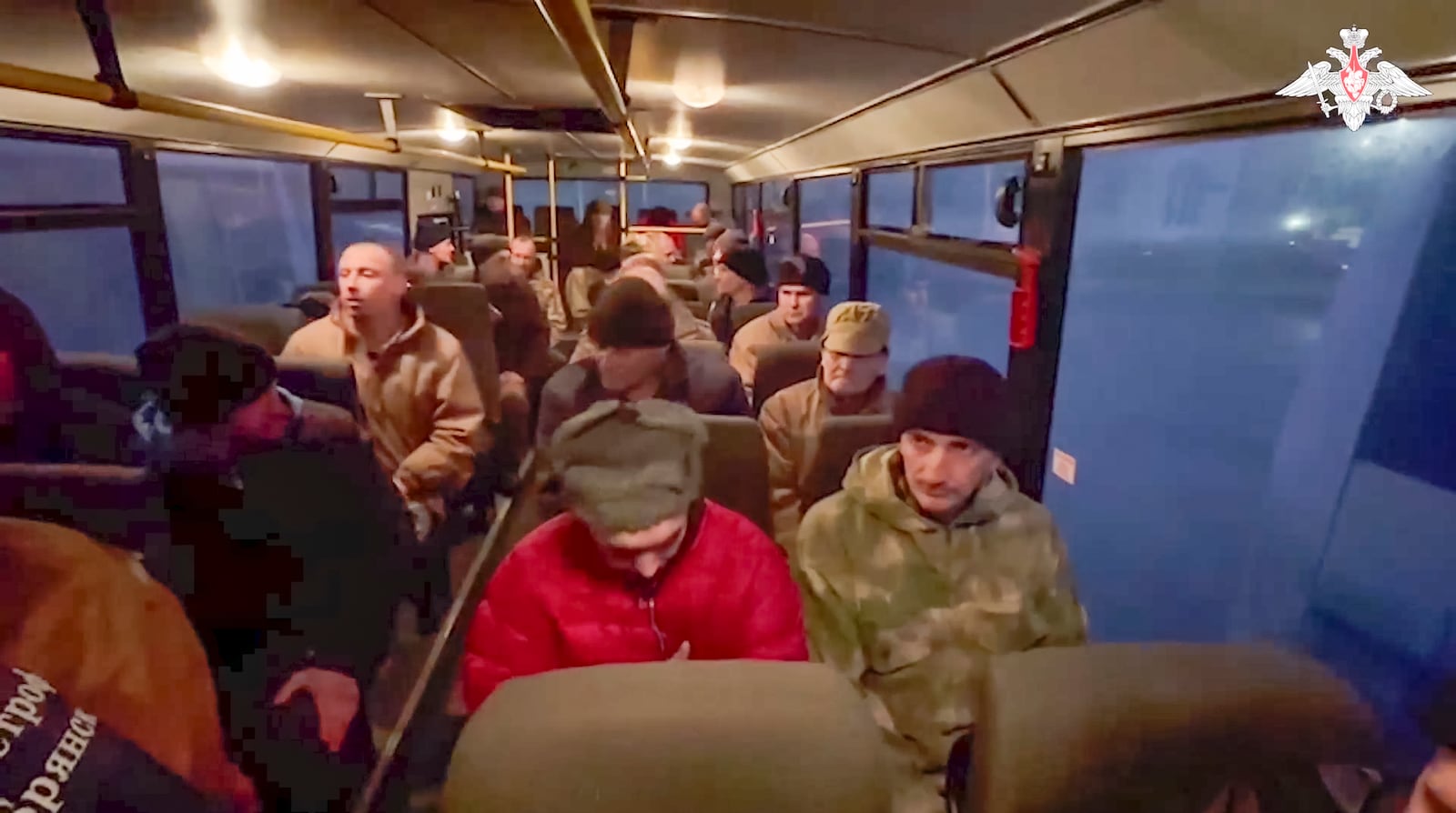 In this photo taken from video released by the Russian Defense Ministry Press Service on Monday, Dec. 30, 2024, a group of Russian soldiers sit in a bus after being released in a prisoners swap between Russia and Ukraine, at an unspecified location in Belarus. (Russian Defense Ministry Press Service via AP)