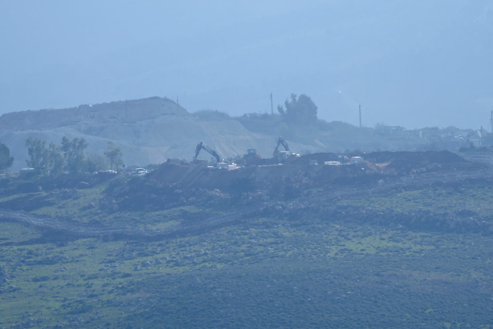 Israeli bulldozers work on the Hamamis hill near the town of Khiam, southern Lebanon, Monday, Feb. 17, 2025. (AP Photo/Hassan Ammar)