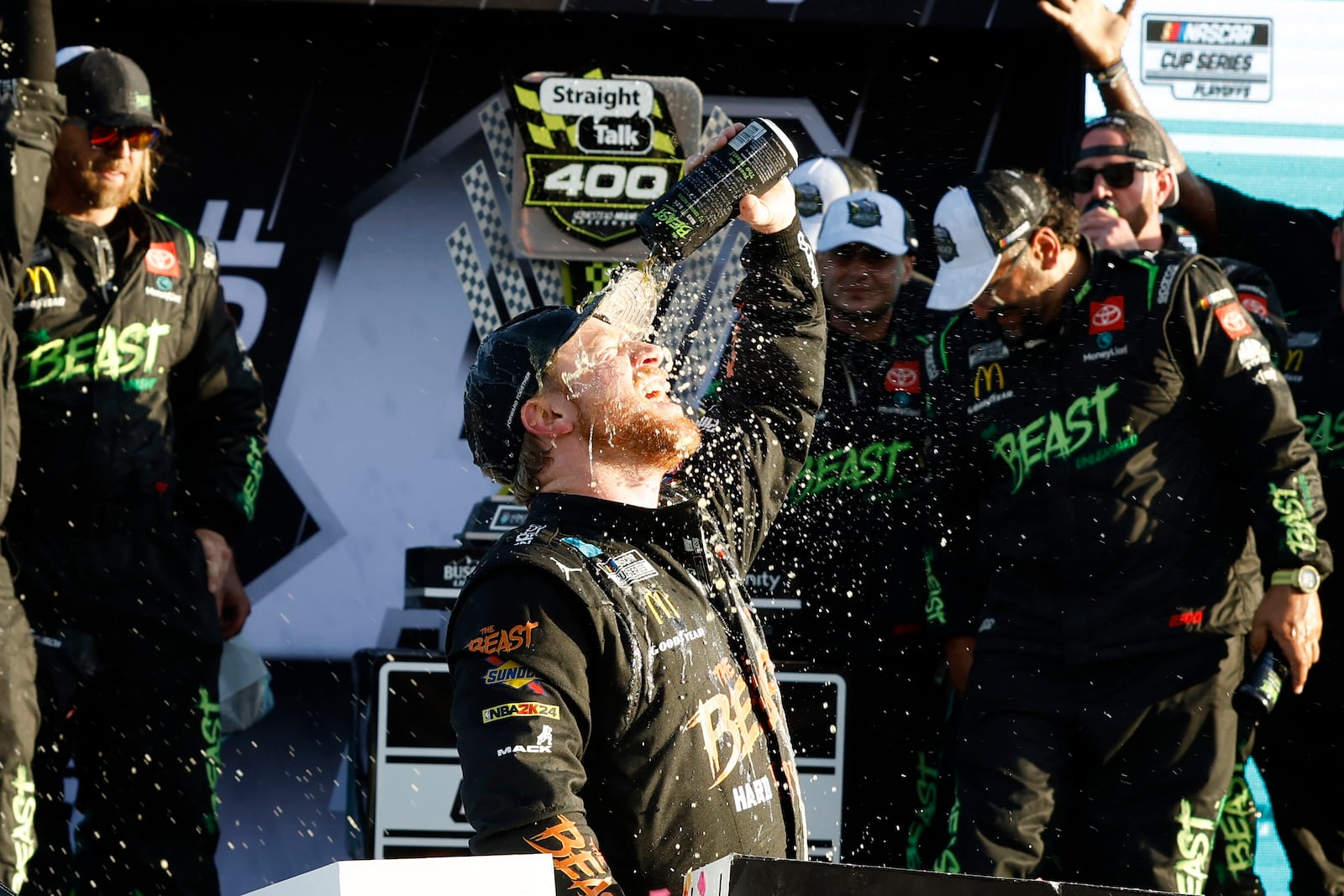 Tyler Reddick, center, celebrates in Victory Lane after winning a NASCAR Cup Series auto race at Homestead-Miami Speedway in Homestead, Fla., Sunday, Oct. 27, 2024. (AP Photo/Terry Renna)