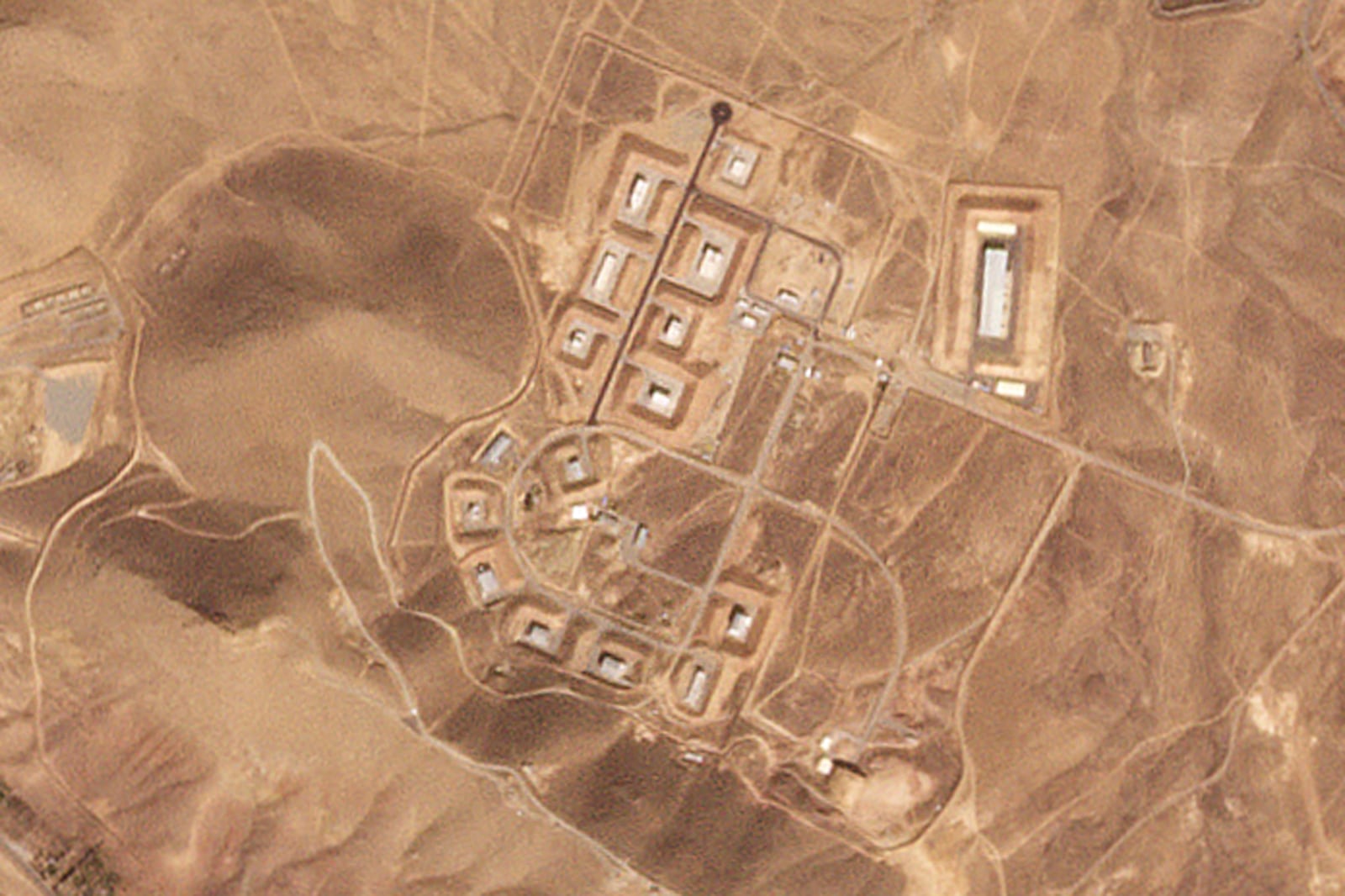 This satellite photo from Planet Labs PBC shows damaged buildings at Iran's Khojir military base outside of Tehran, Iran, Oct. 8, 2024. An Israeli attack on Iran damaged facilities at a secretive military base southeast of the Iranian capital that experts in the past have linked to Tehran's onetime nuclear weapons program and at another base tied to its ballistic missile program, satellite photos analyzed Sunday, Oct. 27, 2024, by The Associated Press show. (Planet Labs PBC via AP)