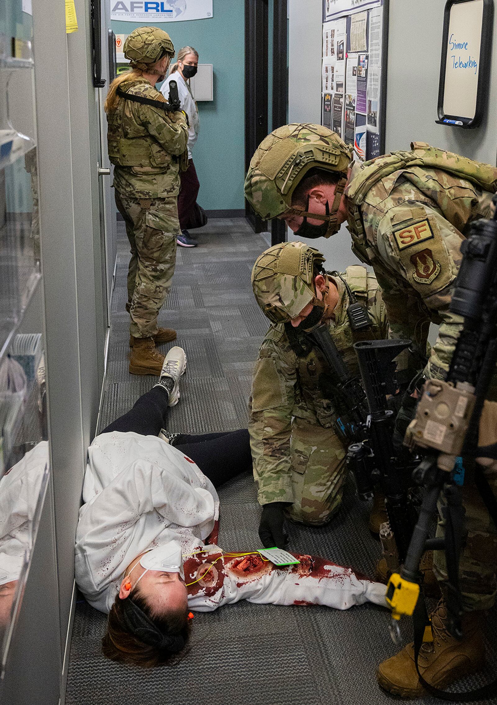 Defenders with the 88th Security Forces Squadron check on a person playing the role of a victim as part of an active-shooter exercise Feb. 23 at Wright-Patterson Air Force Base. The drill was held as part of WPAFB’s regularly scheduled training to prepare for possible emergency scenarios. U.S. AIR FORCE PHOTO/R.J. ORIEZ