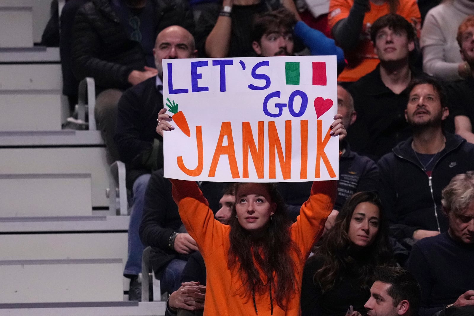 A supporter of Italy's Jannik Sinner holds up a sign during the singles tennis match of the ATP World Tour Finals between Australia's Alex de Minaur and Italy's Jannik Sinner, at the Inalpi Arena, in Turin, Italy, Sunday, Nov. 10, 2024. (AP Photo/Antonio Calanni)