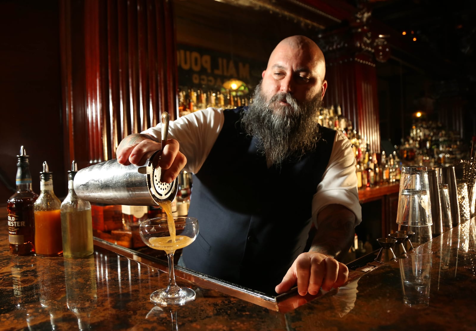 Century Bar co-owner Joe Head pours his seasonal cocktail the Sleepy Holler. JIM WITMER/STAFF