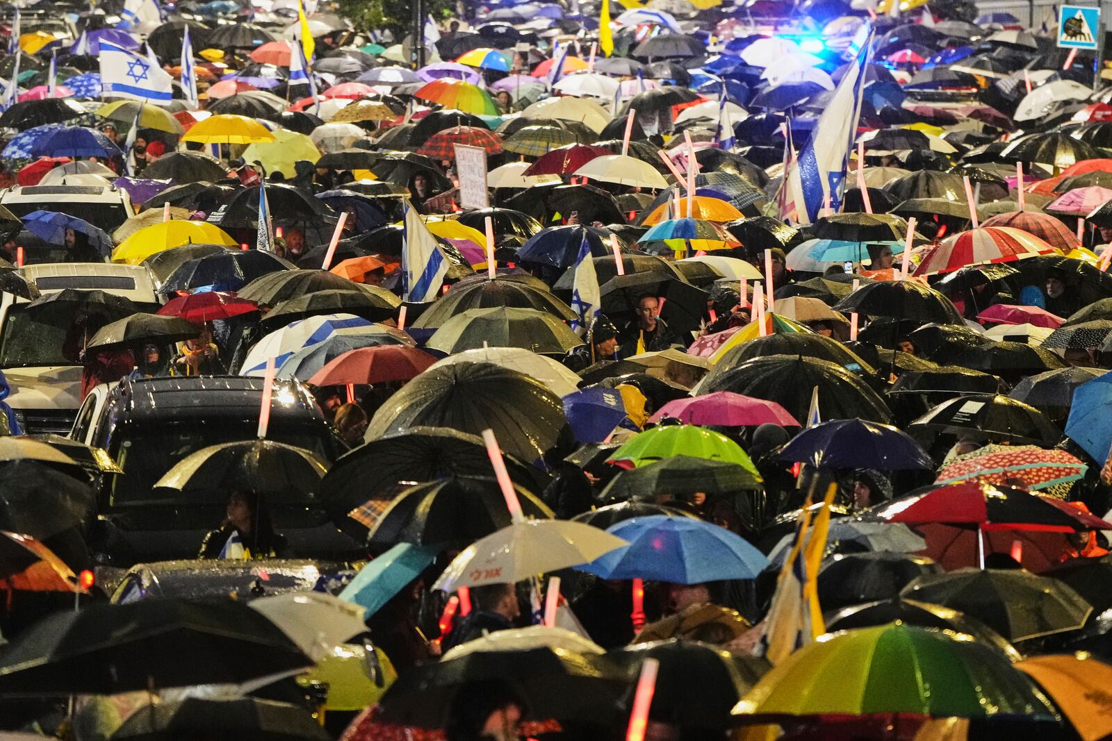 Israelis attend a rally against Prime Minister Benjamin Netanyahu's plan to dismiss the head of the Shin Bet internal security service, and calling for the release of hostages held by Hamas in the Gaza Strip, outside the Knesset, Israel's parliament in Jerusalem on Thursday, March 20, 2025. (AP Photo/Ohad Zwigenberg)