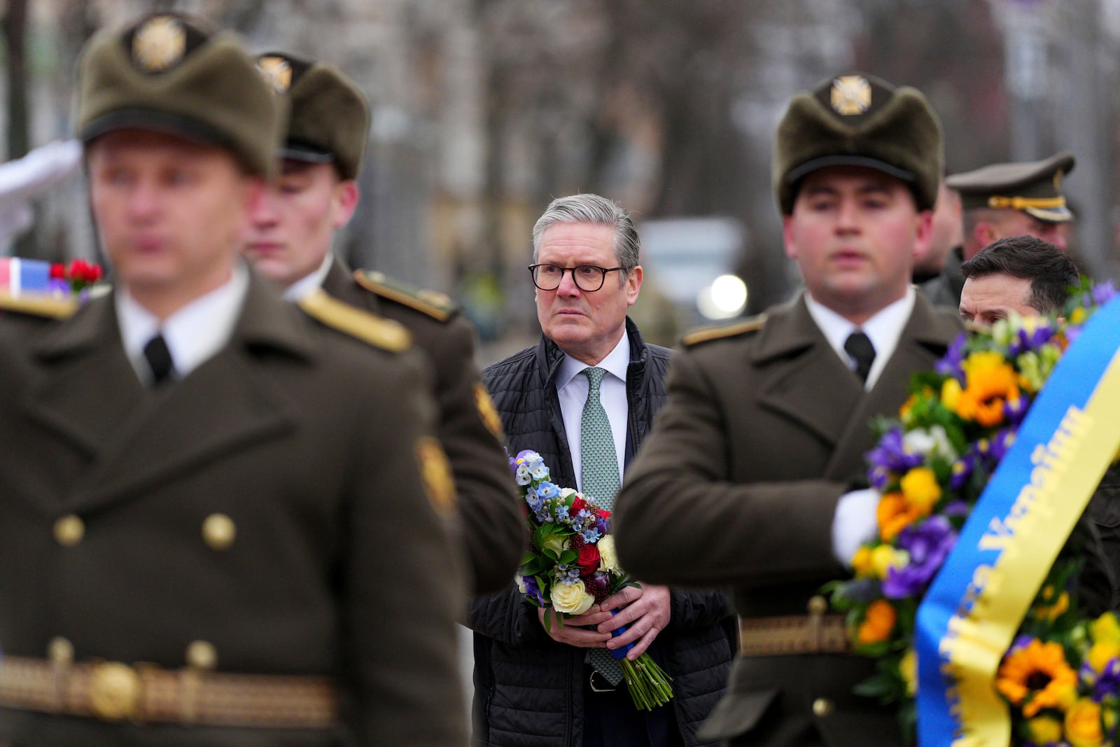 British Prime Minister Keir Starmer arrives with Ukrainian President Volodymyr Zelenskyy to lay wreaths at The Wall of Remembrance of the Fallen for Ukraine, in Kyiv, Ukraine Thursday, Jan. 16, 2025. (Carl Court/Pool Photo via AP)