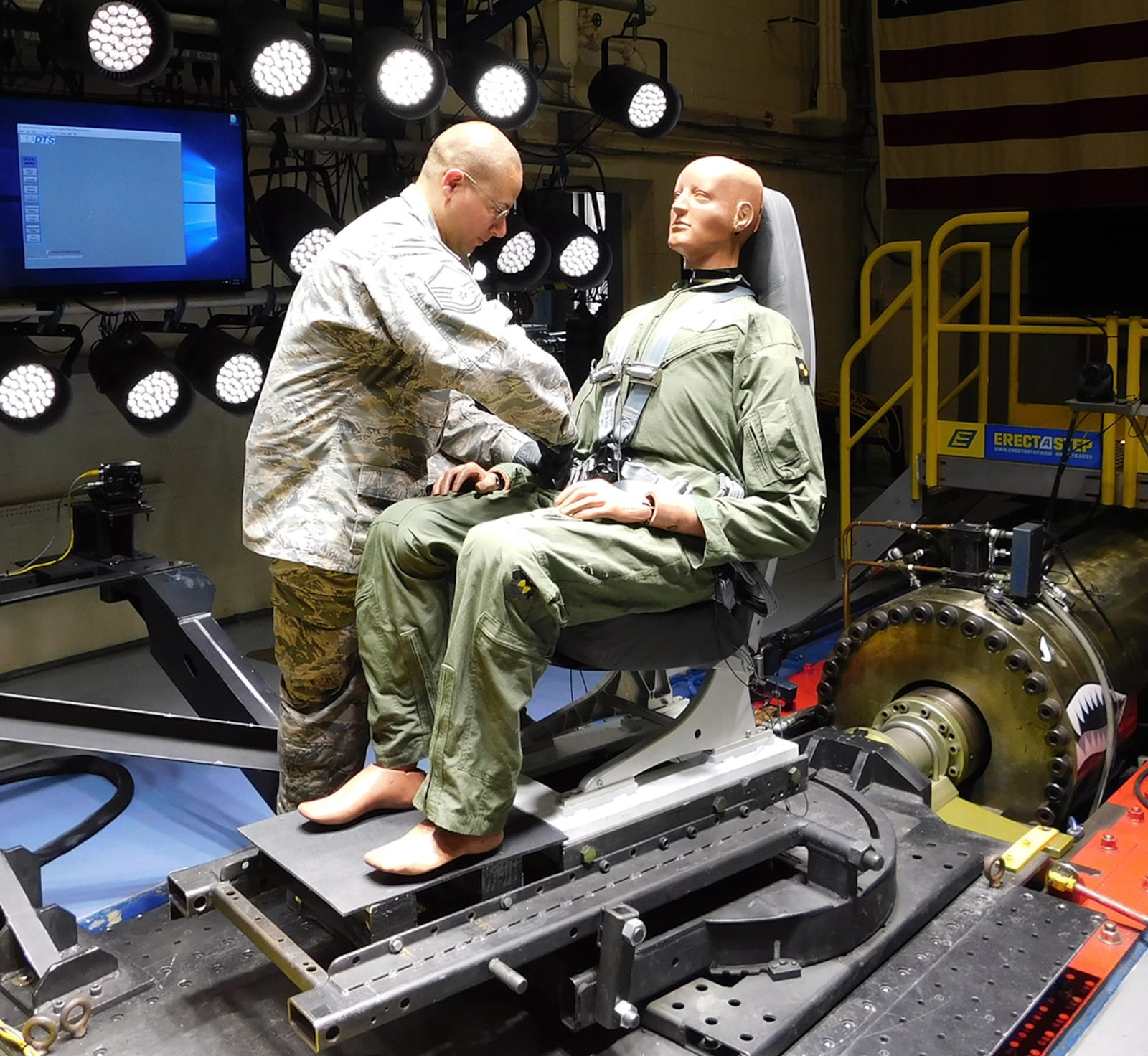 Master Sgt. James Chase of Air Force Research Laboratory’s 711th Human Performance Wing Biodynamics team prepares an instrumented 250-pound test device, simulating a human occupant, for seat testing on the Horizontal Impulse Accelerator, located at Wright-Patterson Air Force Base. The test is one of a series recently conducted to support the acceptance and implementation of the Portable Biocontainment Care Module, which will aid in the safe transport of personnel affected by infectious diseases, including COVID-19. COURTESY PHOTO/INFOSCITEX CORP., CHRISTOPHER ALBERY