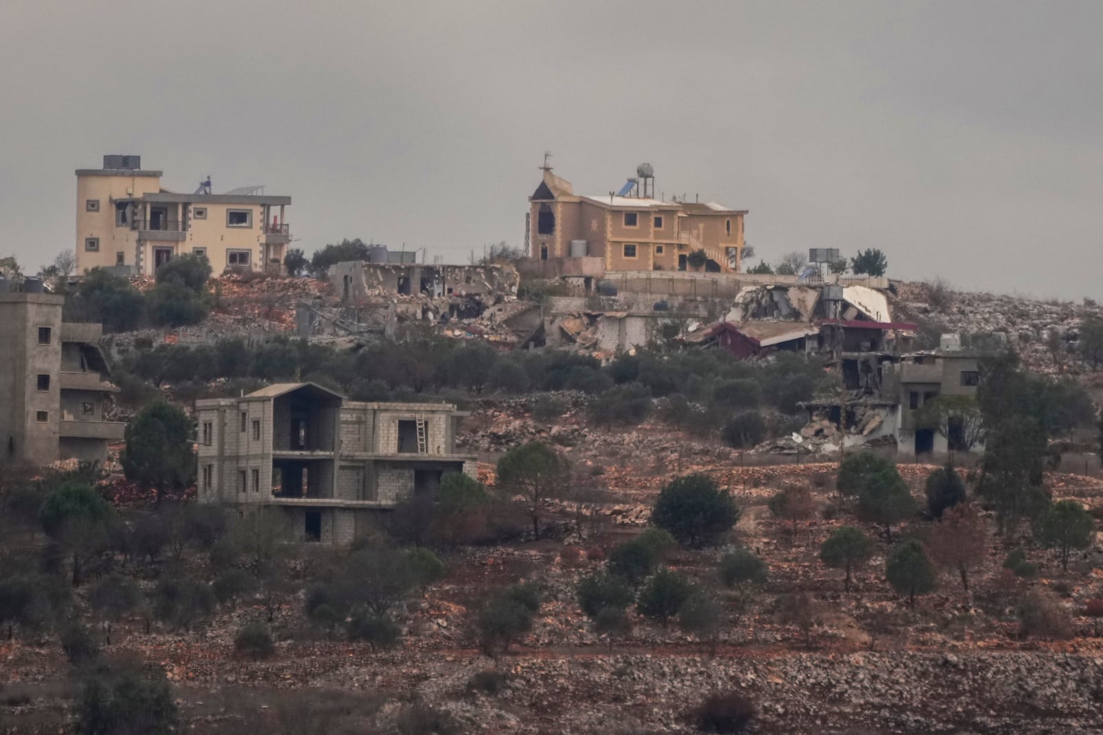 Destroyed buildings stand in the area of a village in southern Lebanon as seen from northern Israel, Wednesday, Nov. 27, 2024. (AP Photo/Francisco Seco)