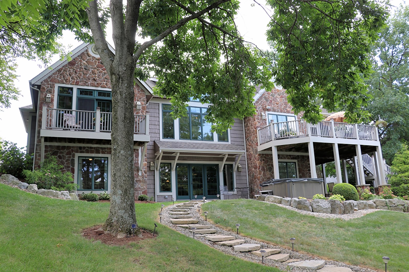 The breakfast room has a wall of windows and oversized patio doors that open to a screen-enclosed porch. The porch opens to a balcony deck with staircase that leads down to the back yard. CONTRIBUTED PHOTO BY KATHY TYLER