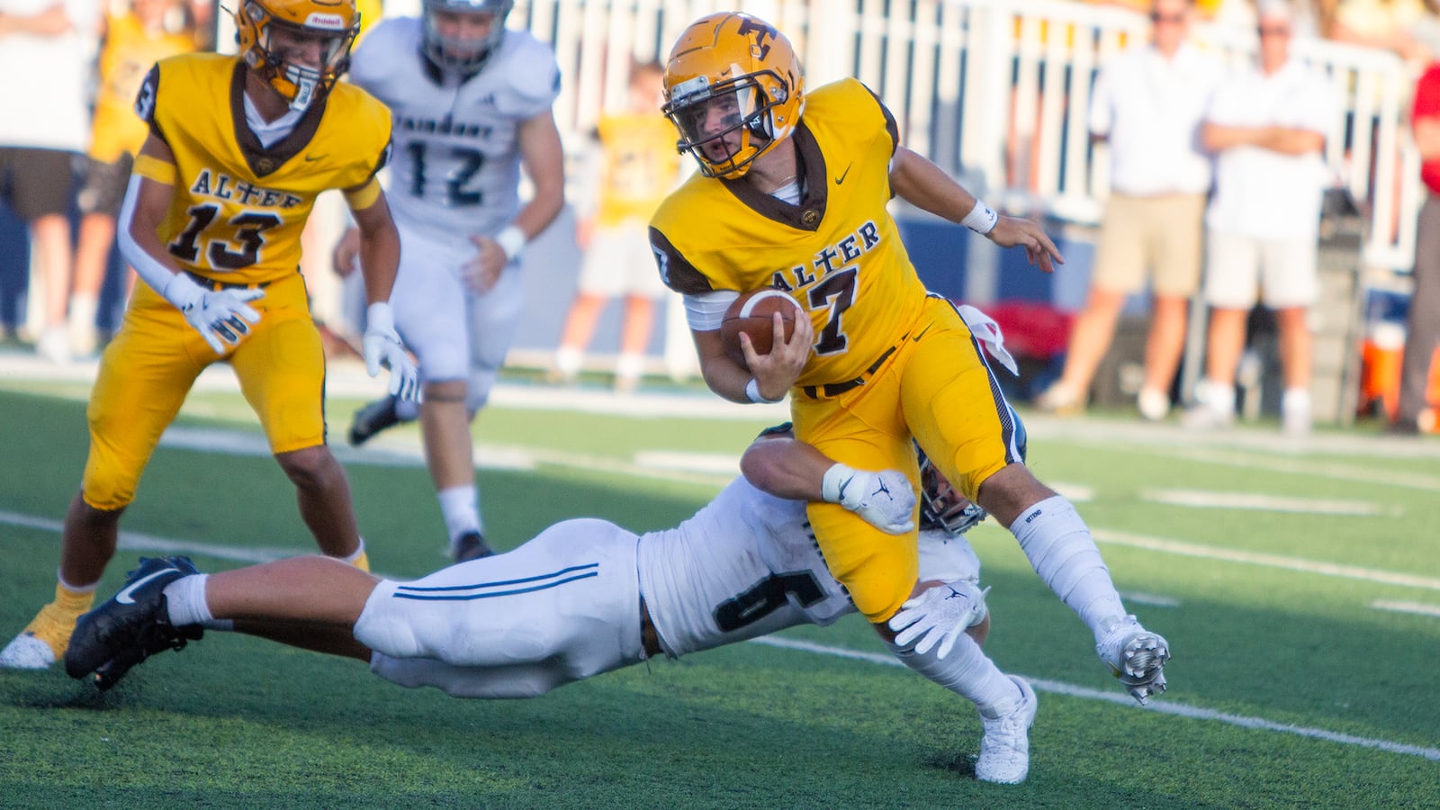 Alter quarterback Gavin Connor runs against Fairmont's Skyler Slifer during Thursday night's 24-7 Fairmont victory. Jeff Gilbert/CONTRIBUTED