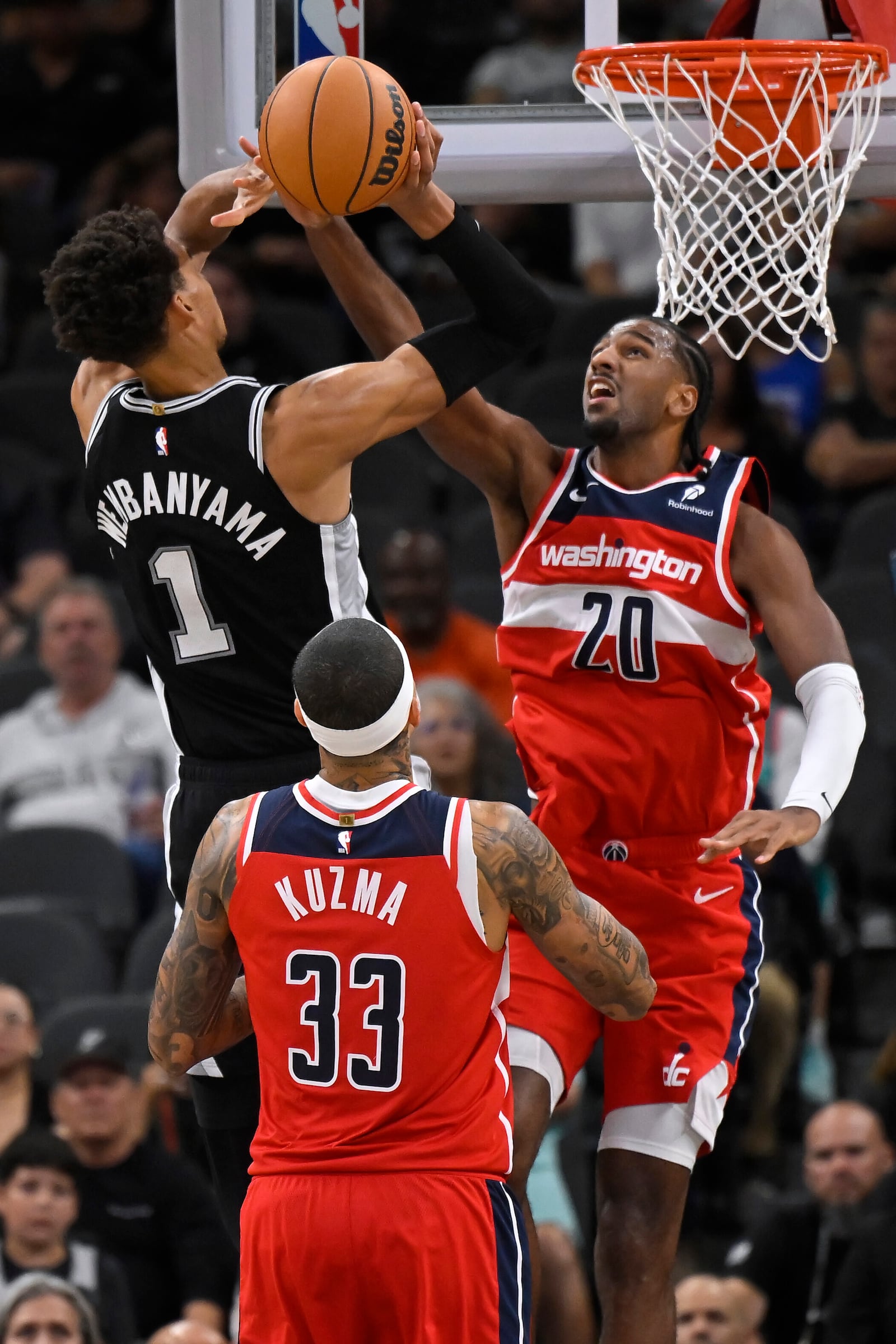 San Antonio Spurs' Victor Wembanyama (1) shoots against Washington Wizards' Alex Sarr (20) during the first half of an NBA basketball game, Wednesday, Nov. 13, 2024, in San Antonio. (AP Photo/Darren Abate)