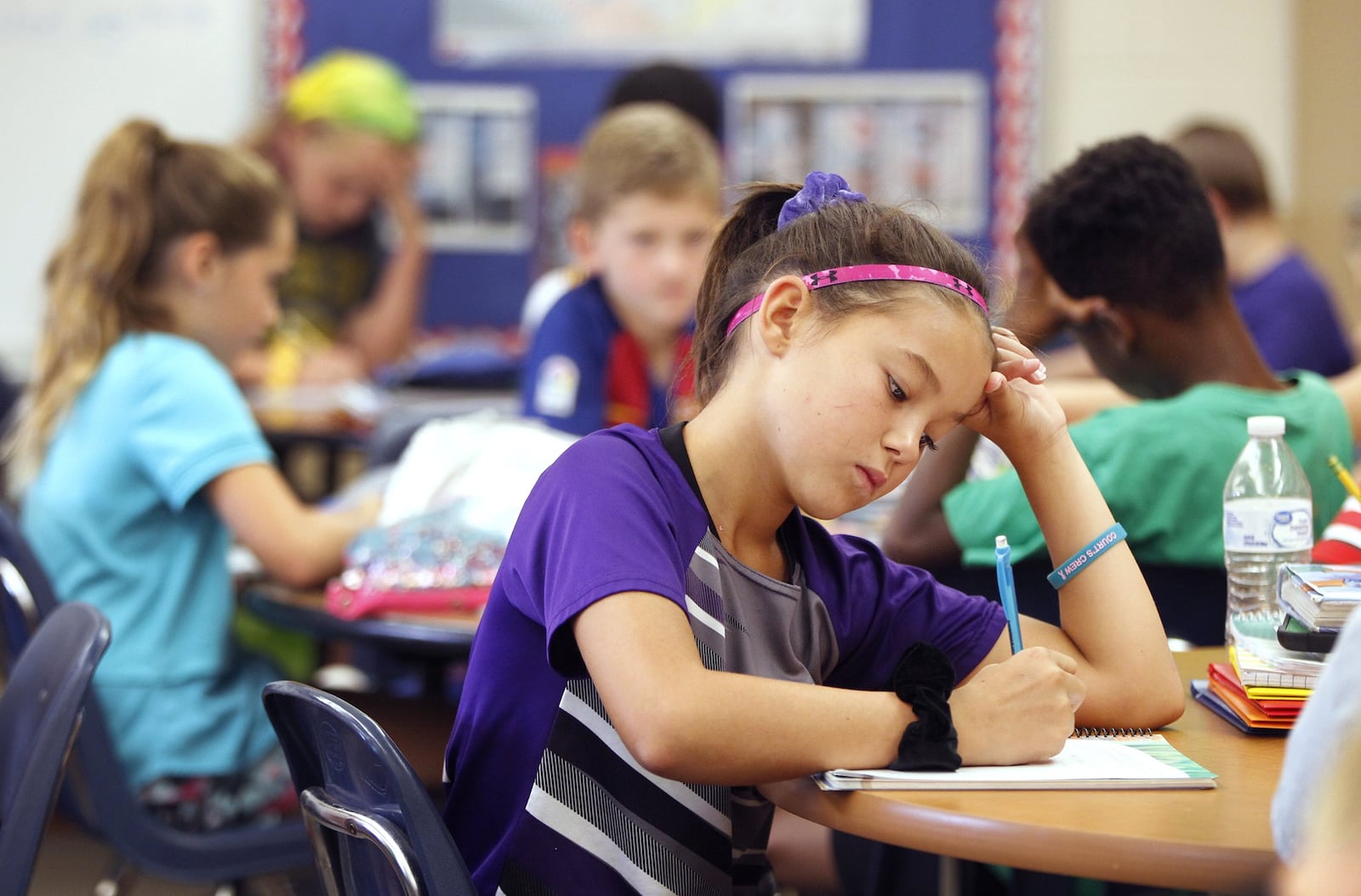 McKenna Myer, a fourth grade student at Northmoor Elementary School in Englewood, writes in a journal during class. The practice is an effort to address social-emotional skills. LISA POWELL / STAFF