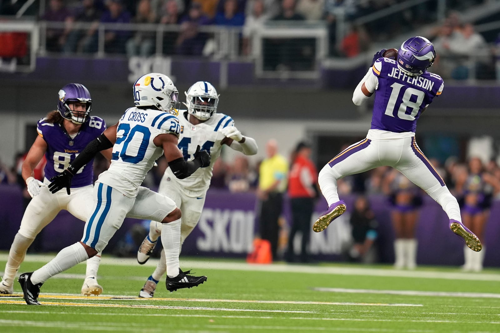 Minnesota Vikings wide receiver Justin Jefferson (18) catches a pass in front of Indianapolis Colts safety Nick Cross (20) during the first half of an NFL football game, Sunday, Nov. 3, 2024, in Minneapolis. (AP Photo/Abbie Parr)