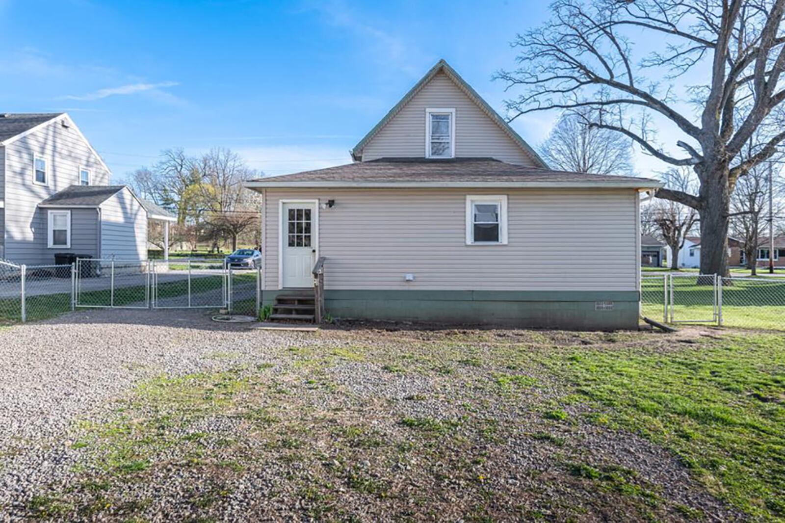 The backyard is fully fenced and has a two-car detached garage.