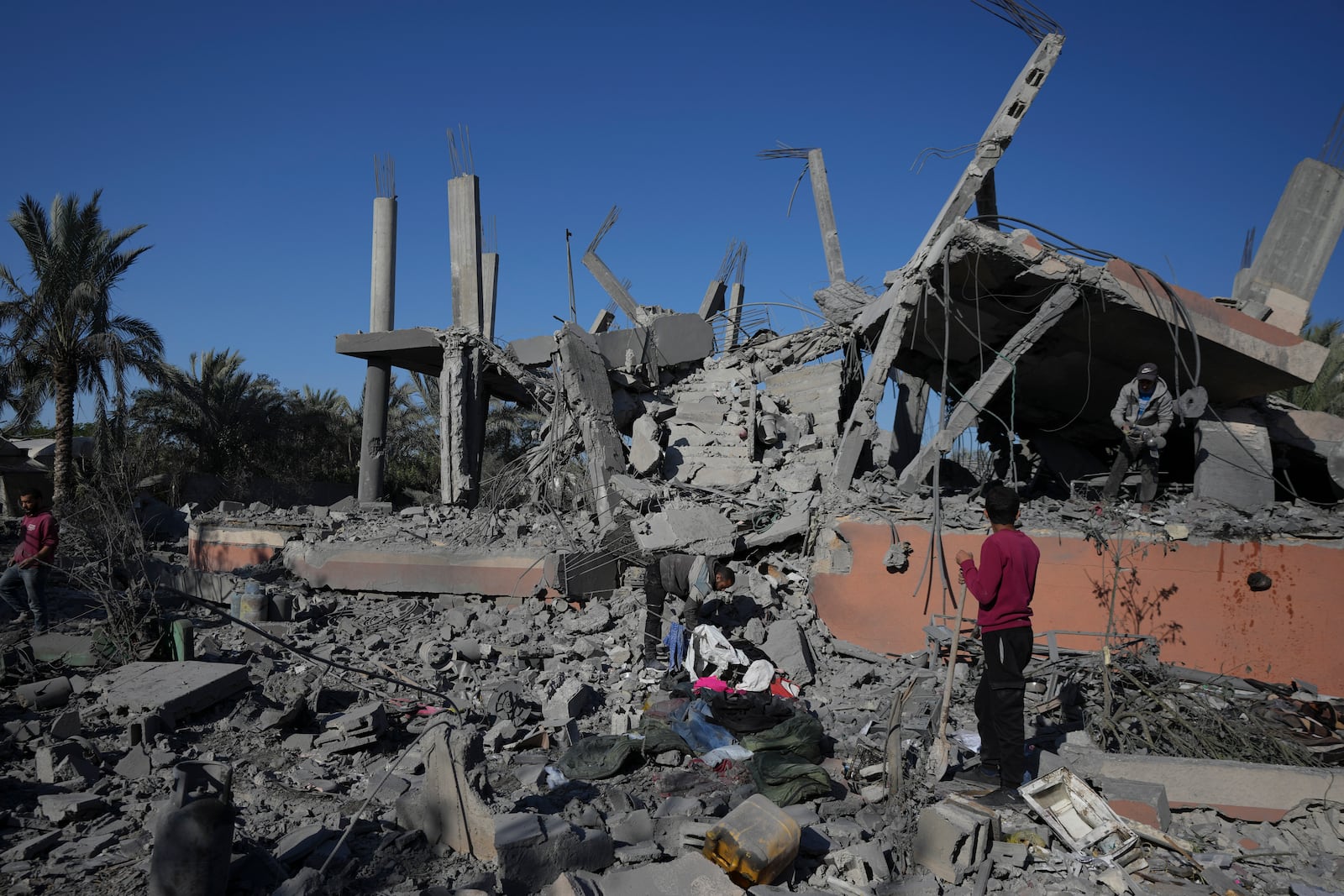 Palestinians check the rubble of a destroyed building following an overnight Israeli strike in Deir al-Balah, Gaza Strip, Wednesday, Dec. 4, 2024. (AP Photo/Abdel Kareem Hana)