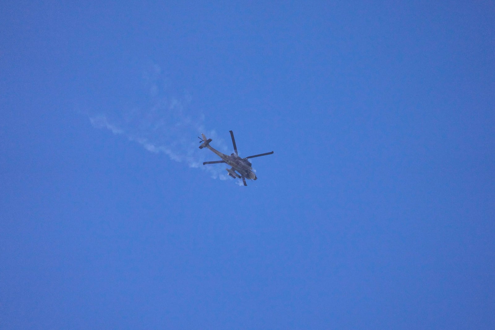 An Israeli Apache helicopter fires towards the Gaza Strip as seen from southern Israel, Wednesday, March 19, 2025. (AP Photo/Ariel Schalit)