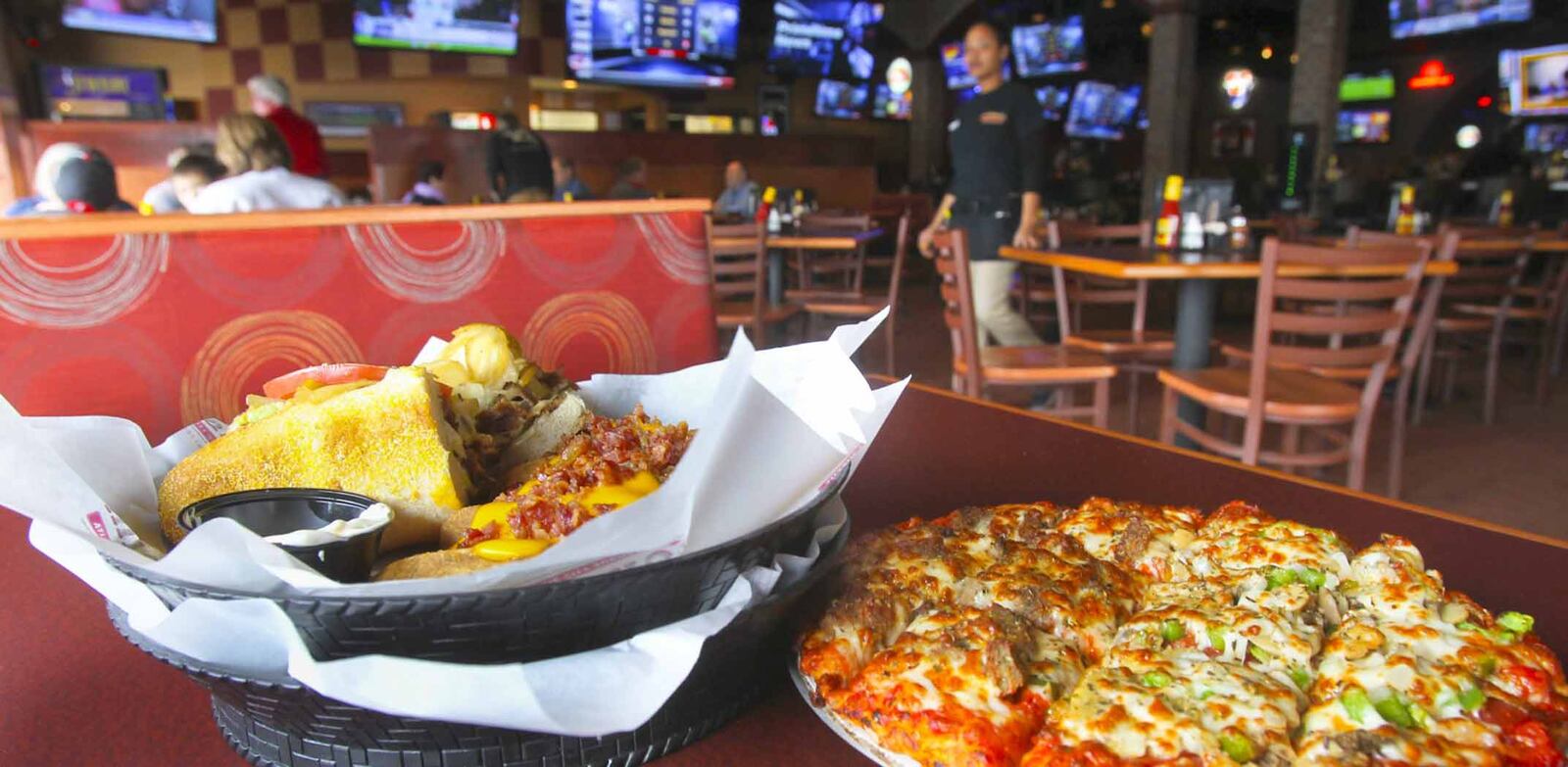 Pizza and a cheese steak submarine sandwich at Milano’s. GREG LYNCH / STAFF