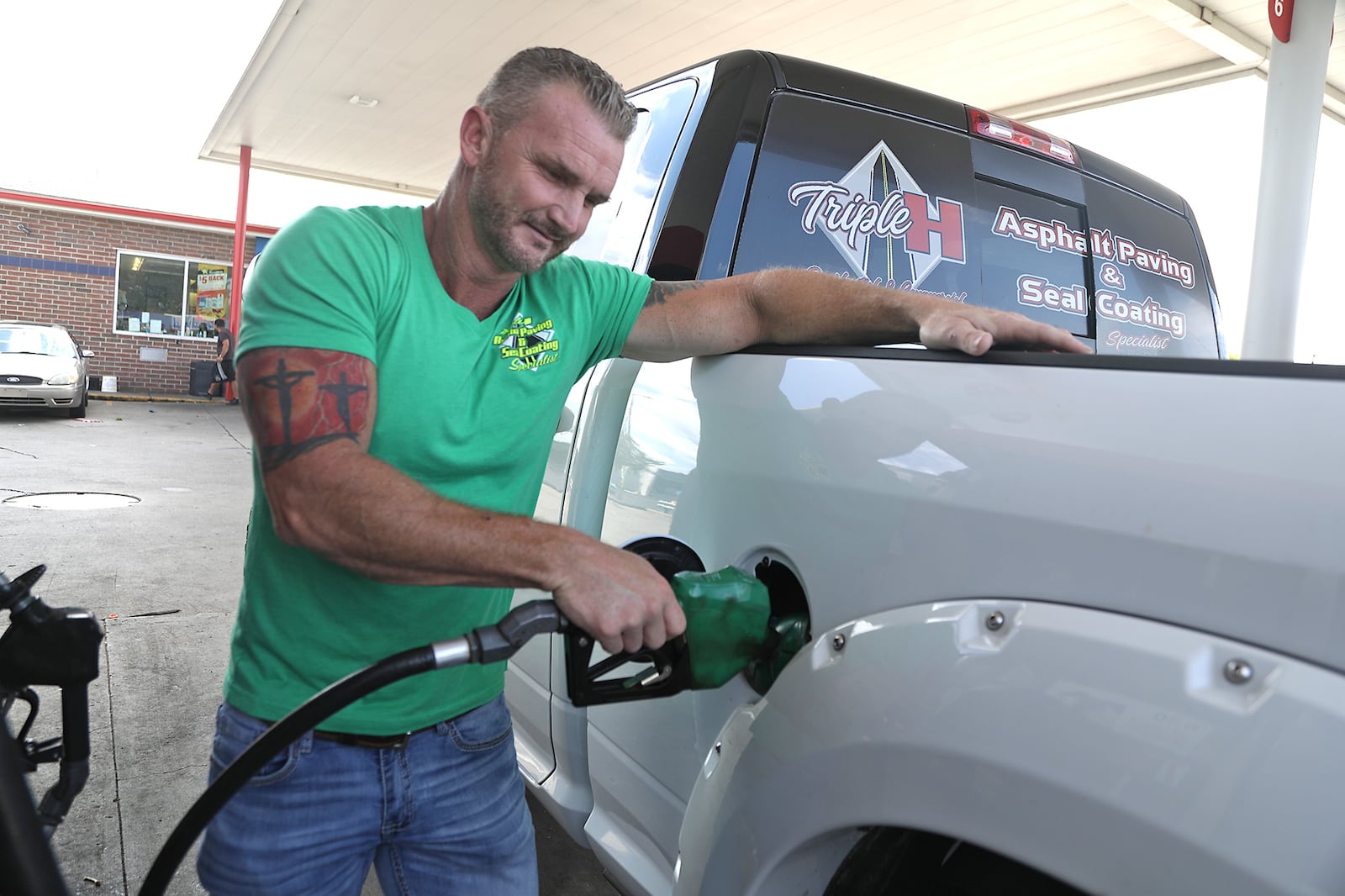 Shawn Harrison fills up his diesel truck at the Speedway gas station along South Limestone Street in Springfield. BILL LACKEY/STAFF