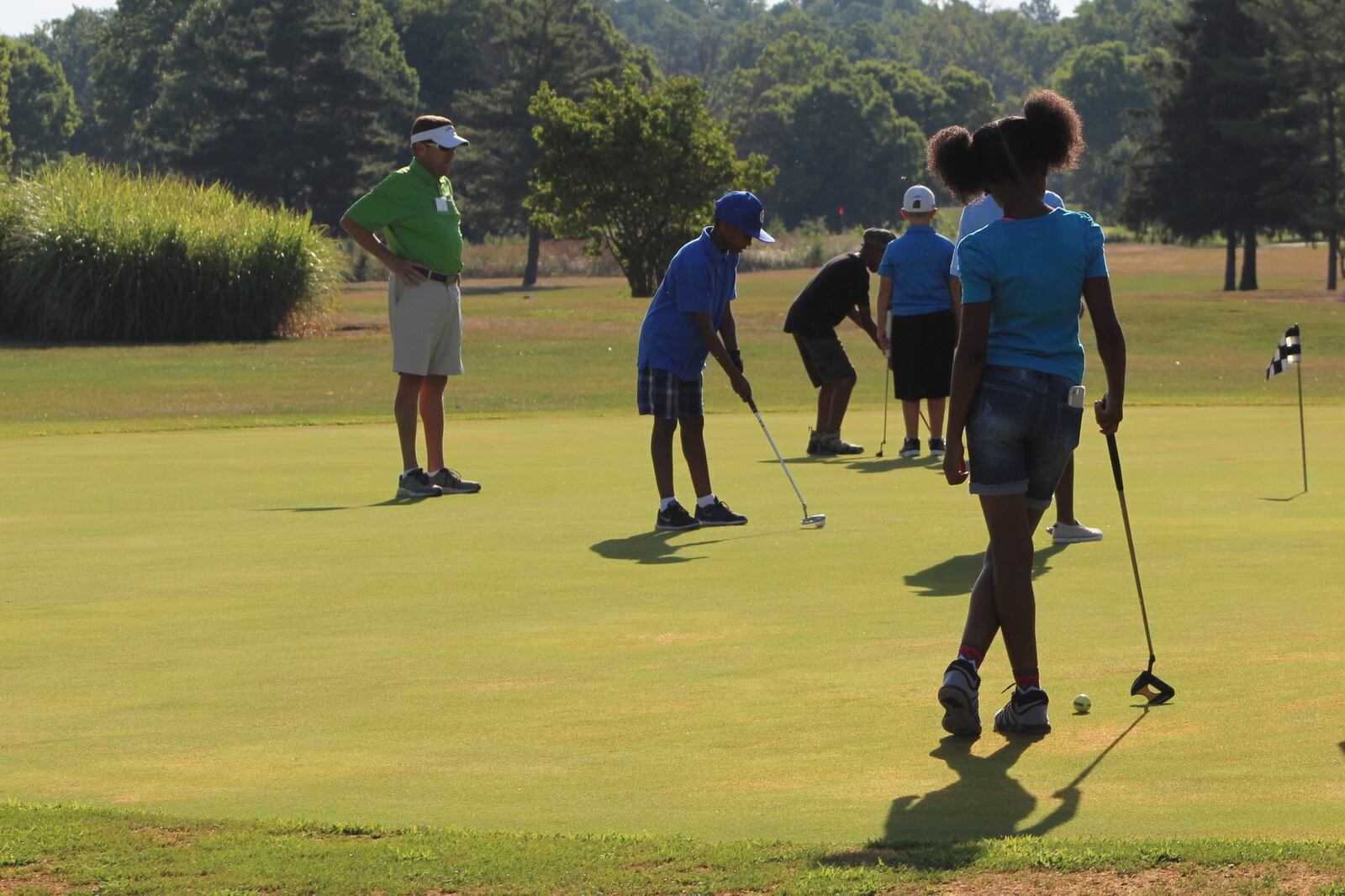 Children practice golf at the city of Dayton’s Madden Golf course. CORNELIUS FROLIK / STAFF