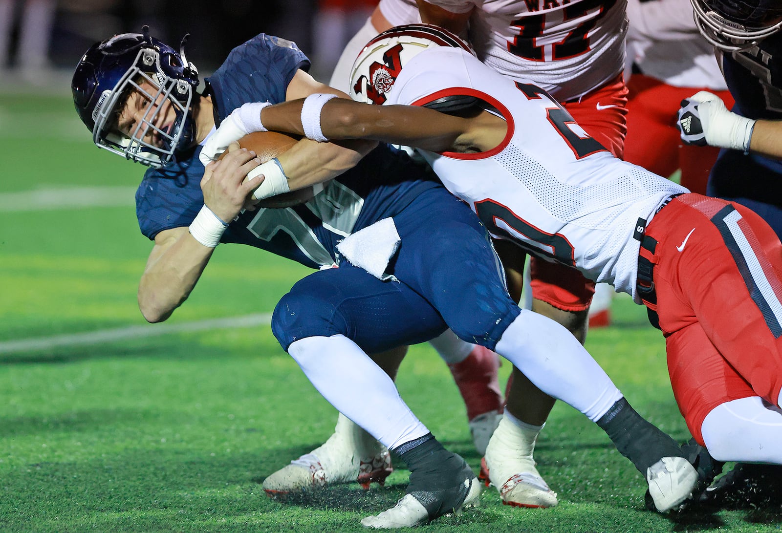 Fairmont's Logan Doty is tackled by Wayne's Coretni Owens during round two of the playoffs Friday, Nov. 8, 2024. BILL LACKEY/STAFF