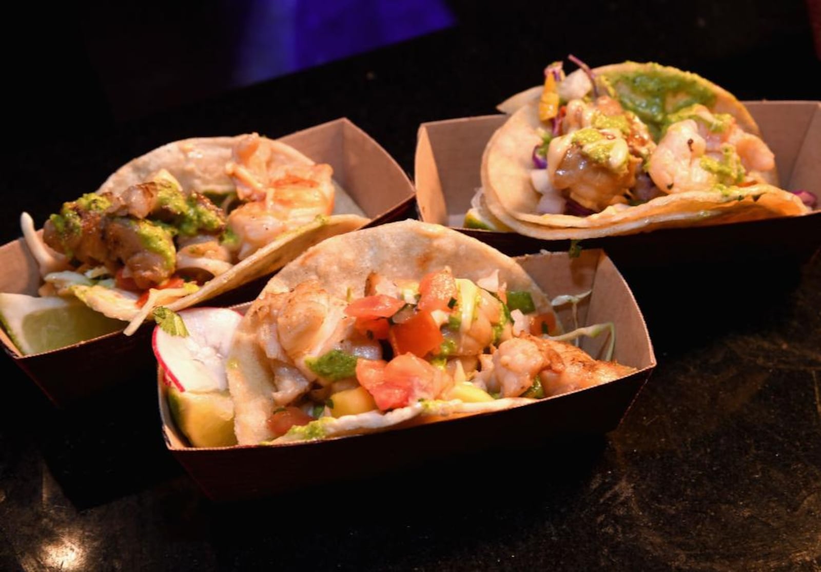 LAS VEGAS, NV - MAY 11:  Lobster tacos are served at Guy Fieri's Vegas Kitchen & Bar booth during the 12th annual Vegas Uncork'd by Bon Appetit Grand Tasting event. Thursday is National Taco Day  2018 where restaurants like Taco Bell, Chuys, Moes and  Cold Stone Creamery are offering deals on tasty tacos. (Photo by Ethan Miller/Getty Images for Vegas Uncork'd by Bon Appetit)