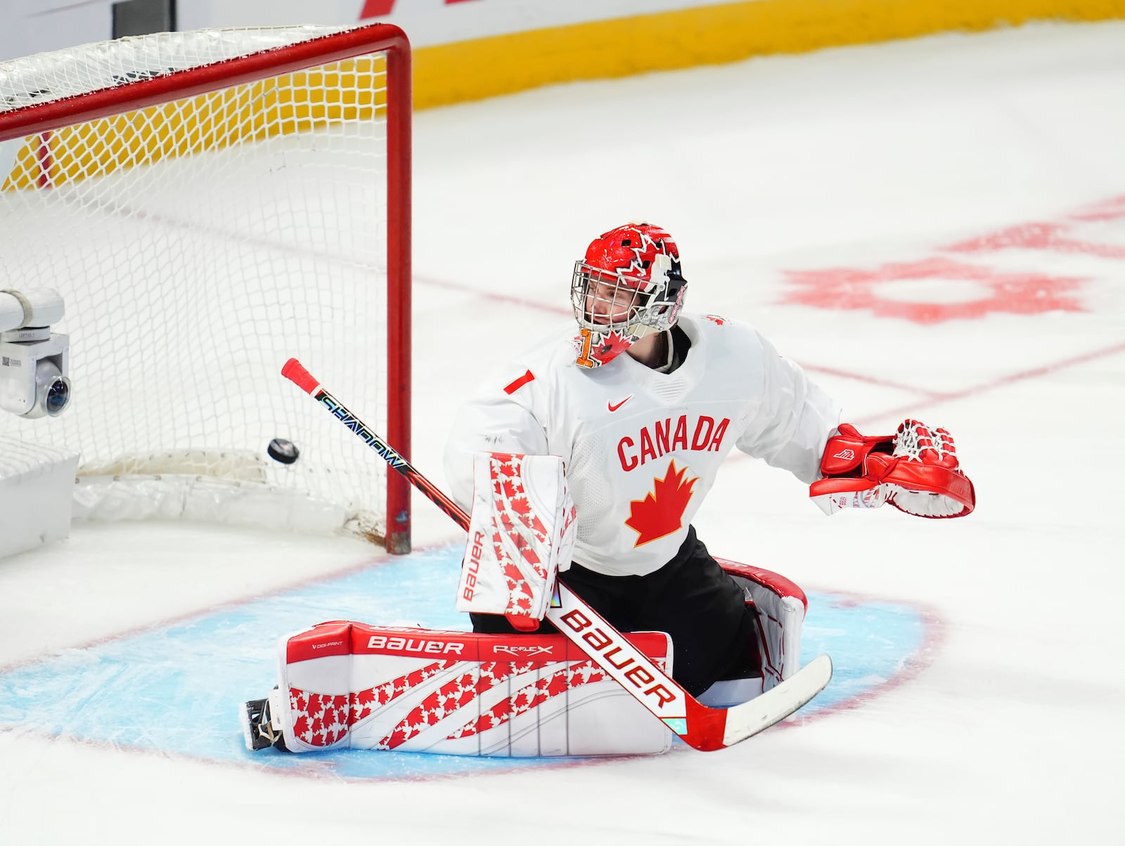 Canada goaltender Jack Ivankovic is scored against by Latvia's Eriks Mateiko during shootout IIHF World Junior Hockey Championship preliminary round game action in Ottawa, Ontario, Friday, Dec. 27, 2024. (Sean Kilpatrick/The Canadian Press via AP)