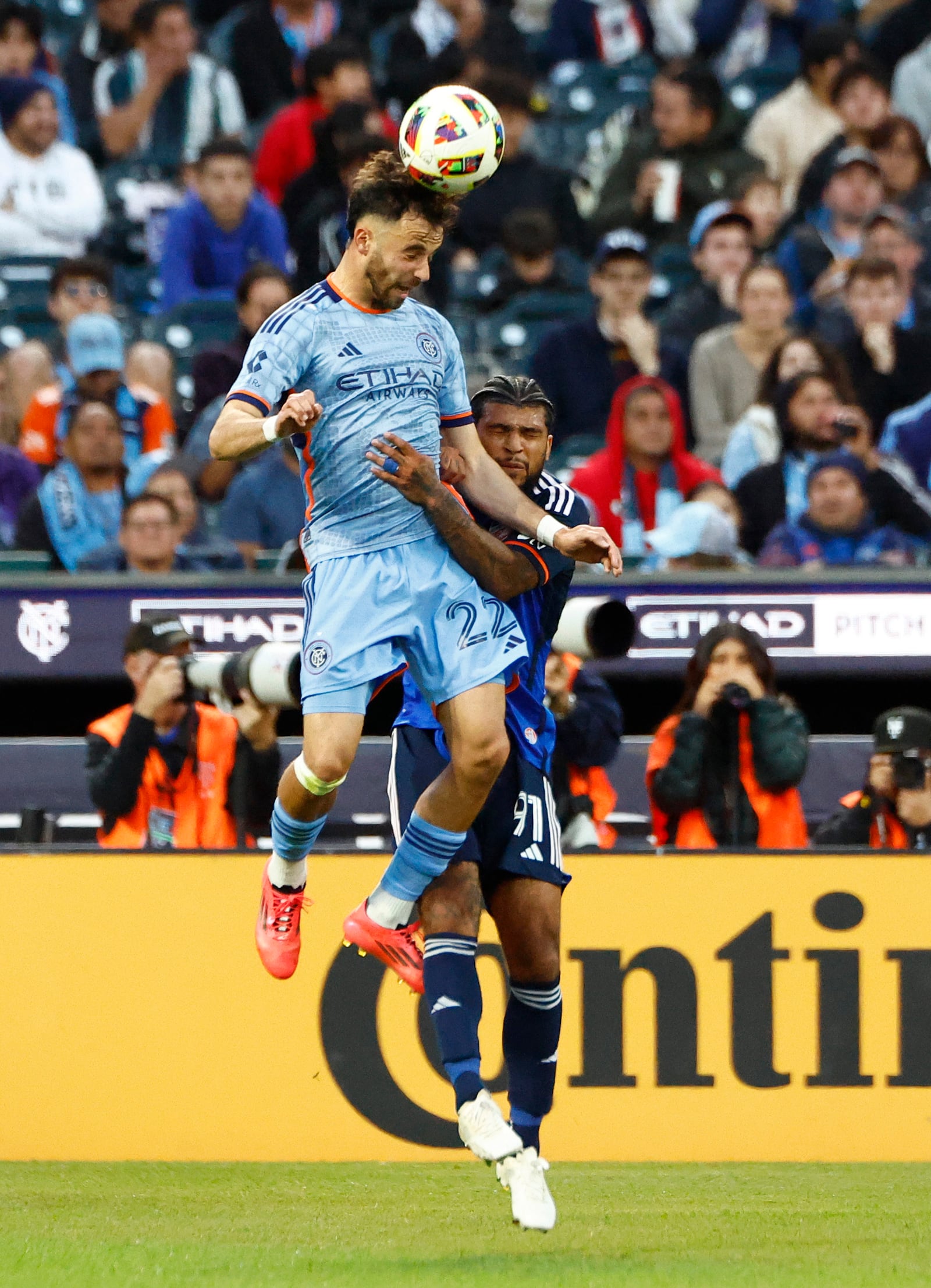 New York City FC's Kevin o"Toole (22) heads the ball over FC Cincinnati's DeAndre Yedlin (91) during the first half in Game 2 in the first round of the MLS Cup soccer playoffs, Saturday, Nov. 2, 2024, in New York. (AP Photo/Kena Betancur)