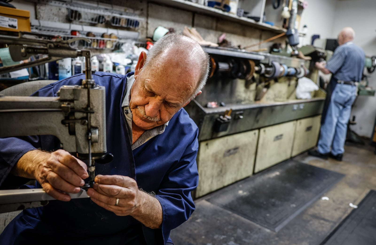 John Strehle works on a soccer shoe at his Kettering store on Woodman Drive. John and his wife, Joyce are closing their store, Strehle's Dry Cleaning & Shoe Repair after 50 of them owner of more than a seven decades old business. JIM NOELKER/STAFF