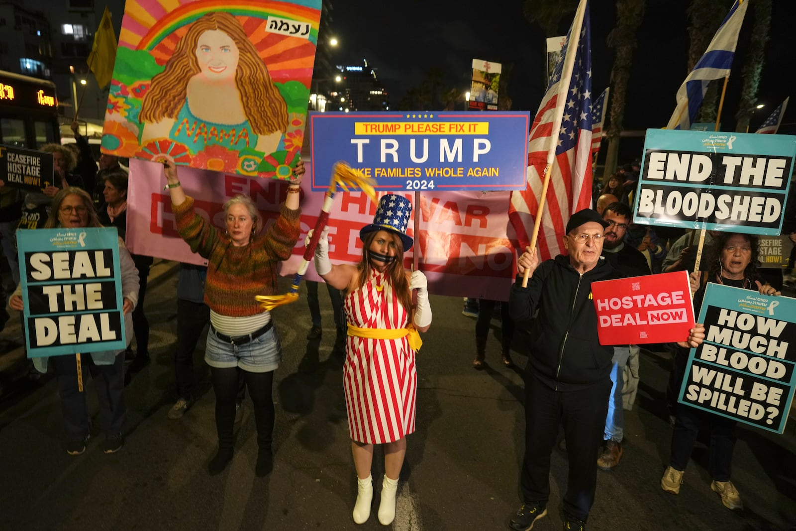 Relatives of hostages held by Hamas in the Gaza Strip and their supporters protest outside of the U.S. Embassy branch office during a visit by White House National Security Adviser Jake Sullivan to call for an immediate hostage release deal, in Tel Aviv, Israel, Thursday, Dec. 12, 2024. (AP Photo/Ariel Schalit)