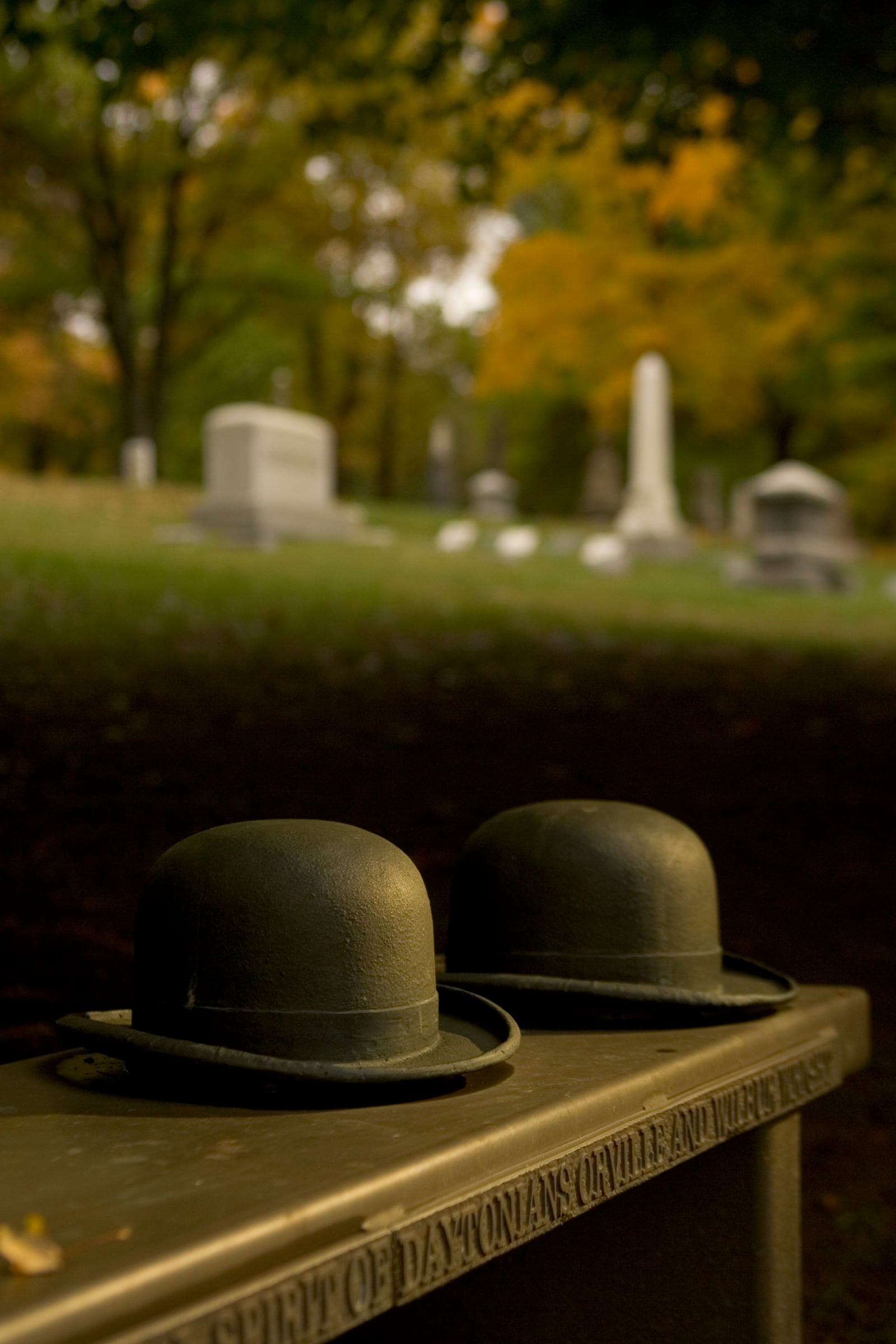 To celebrate Dayton's 200th anniversary, Two bowler hats, traditionally warn by Orville and Wilbur Wright were sculpted into a bench in a grove of Wright Brothers Sugar Maple Trees near the entrance at Woodland Cemetery. Photo by Jim Witmer