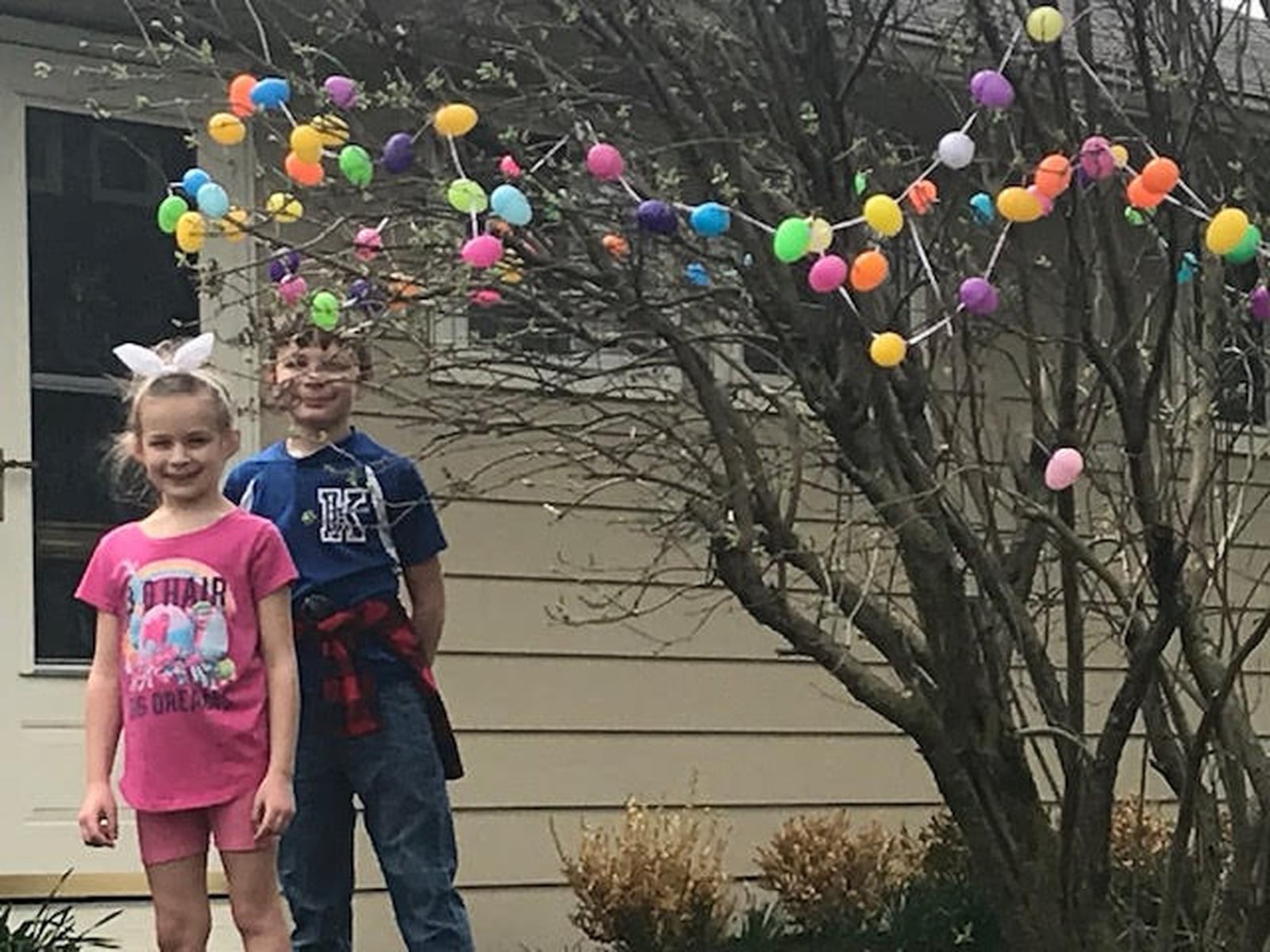 Joy Becker’s grandkids Bradley and Jacqueline Becker hang Easter eggs outside of their great-grandma’s house. CONTRIBUTED