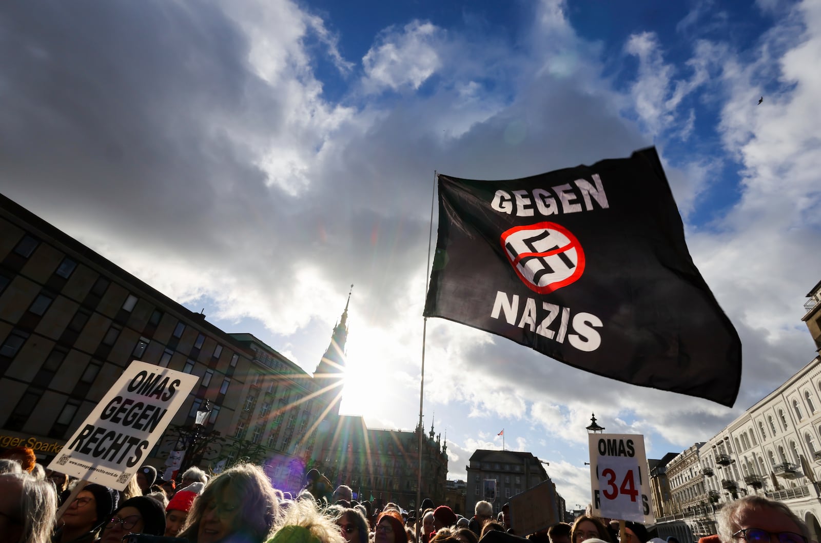 Demosntrators protest under the slogan "Human chain against the AfD and its anti-human policies" demonstrate in the city center with a banner "Against Nazis", in Hamburg, Germany, Friday Jan. 31, 2025. (Christian Charisius/dpa via AP)