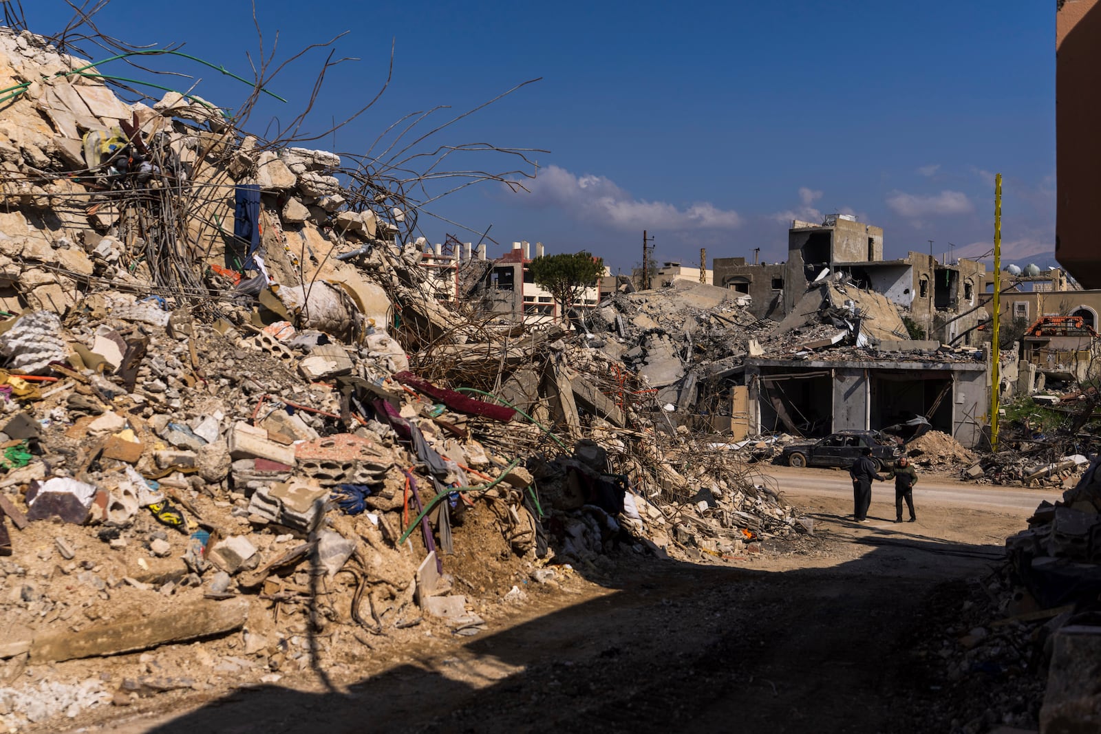 Lebanese citizens check the destruction on their house caused by the Israeli air and ground offensive, in their hometown Khiam, southern Lebanon, Monday, Feb. 17, 2025. (AP Photo/Hassan Ammar)