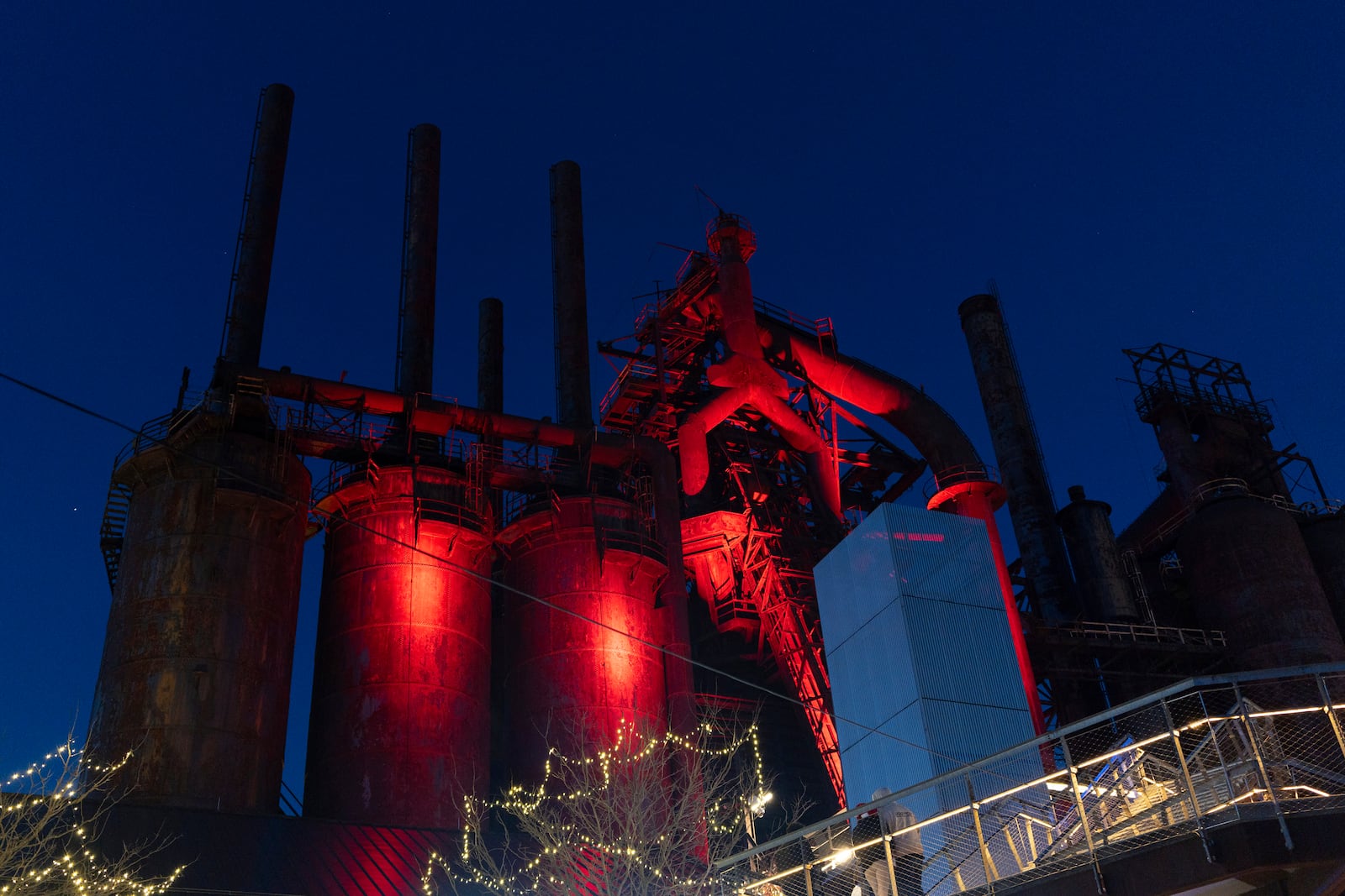 Blast furnaces of the Bethlehem Steel company that once supplied steel for the construction of the Empire State Building and the Golden Gate Bridge, are illuminated next to a Christmas market in Bethlehem, Pa., on Sunday, Dec. 1, 2024.