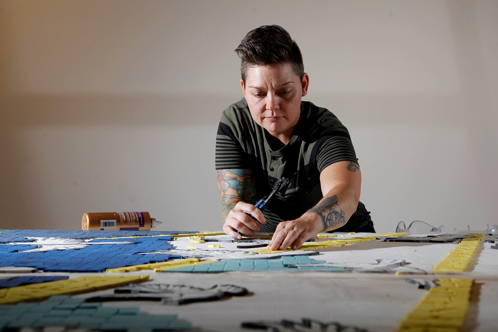 Jes McMillan, founder of The Mosaic Institute of Greater Dayton, along with her staff, designed a mosaic mural, "9 Doves," to commemorate the nine people killed in the Oregon District shooting.  LISA POWELL / STAFF