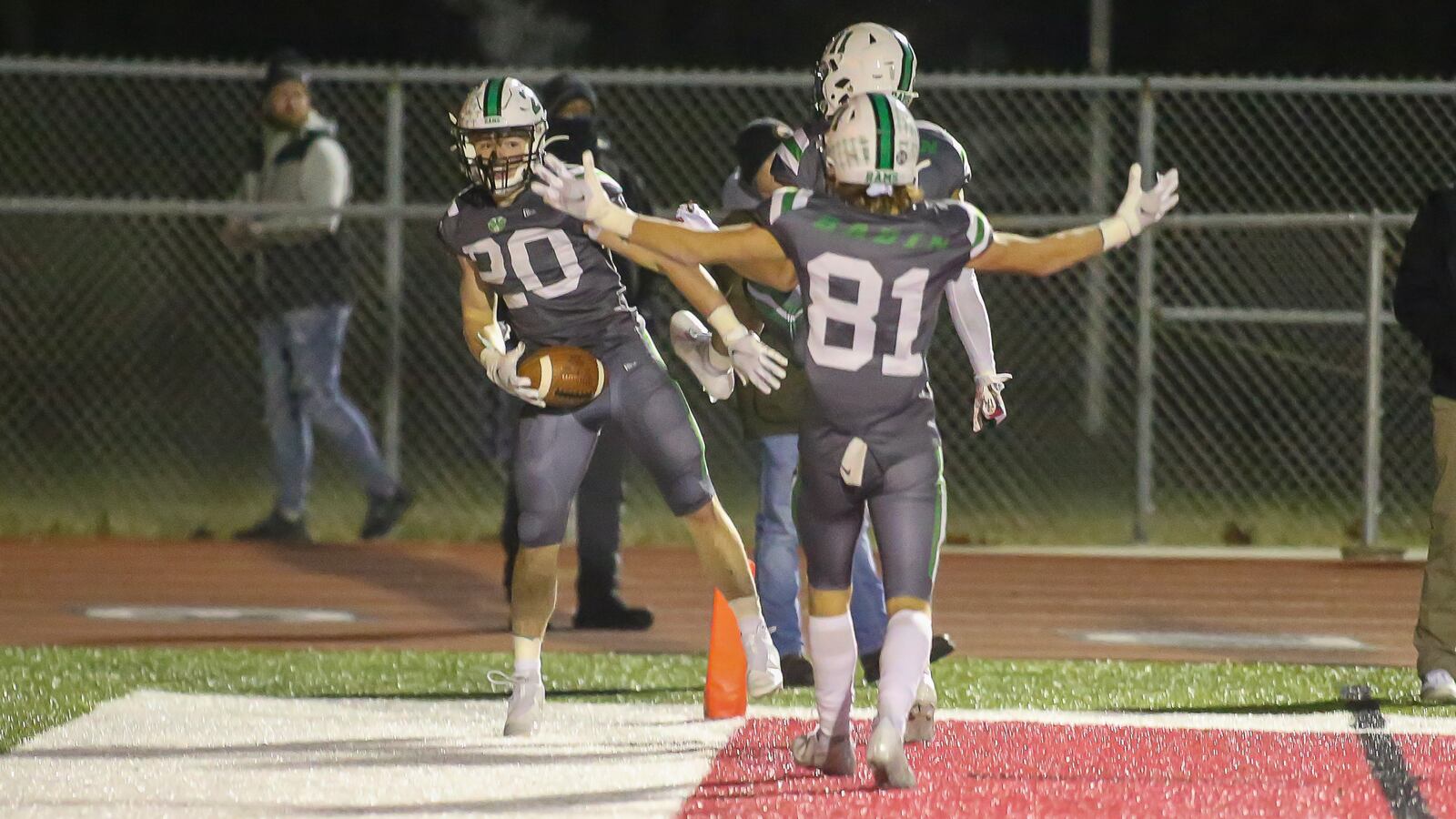 Cutline 1: Badin High School senior running back Jack Walsh and teammates junior Braedyn Moore (11) and senior Eric Rawlings (81) celebrate after Walsh scored to give his team the lead late in the fourth quarter in the Division III, Region 12 final against Bellbrook on Friday night at Trotwood Madison High School. The Rams won 21-9 to advance to the D-III state semifinals. Michael Cooper/CONTRIBUTED