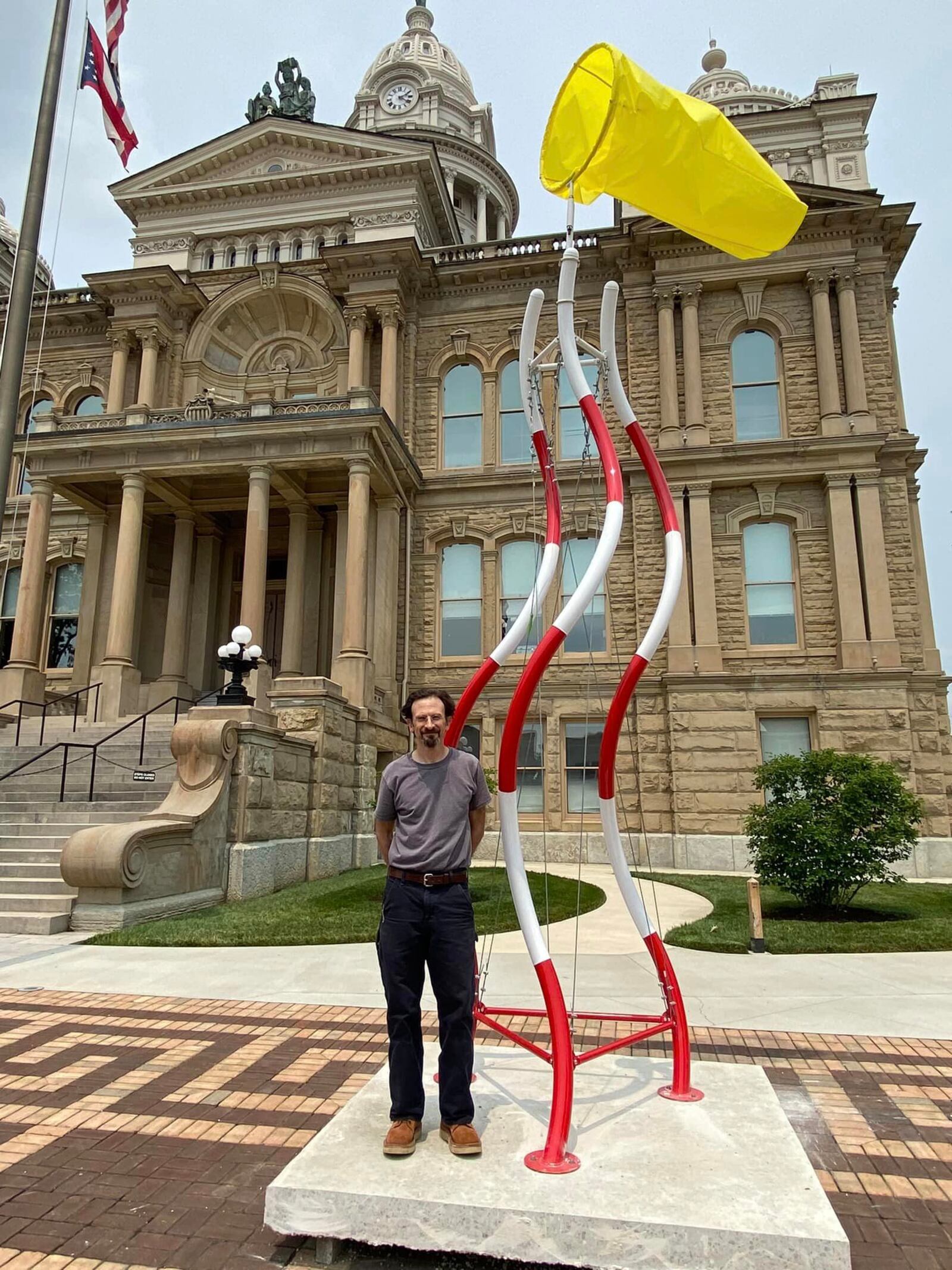 "Windy Tower" stands tall with artist Eric Troffkin on Miami County Courthouse Plaza.