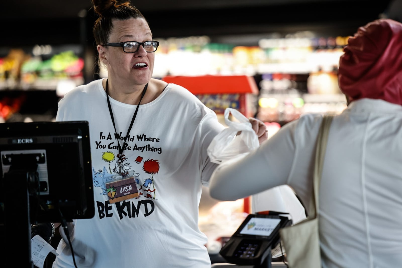 Gem City Market cashier Lisa Henry checks out a customer at the market Thursday morning September 21, 2023. JIM NOELKER/STAFF