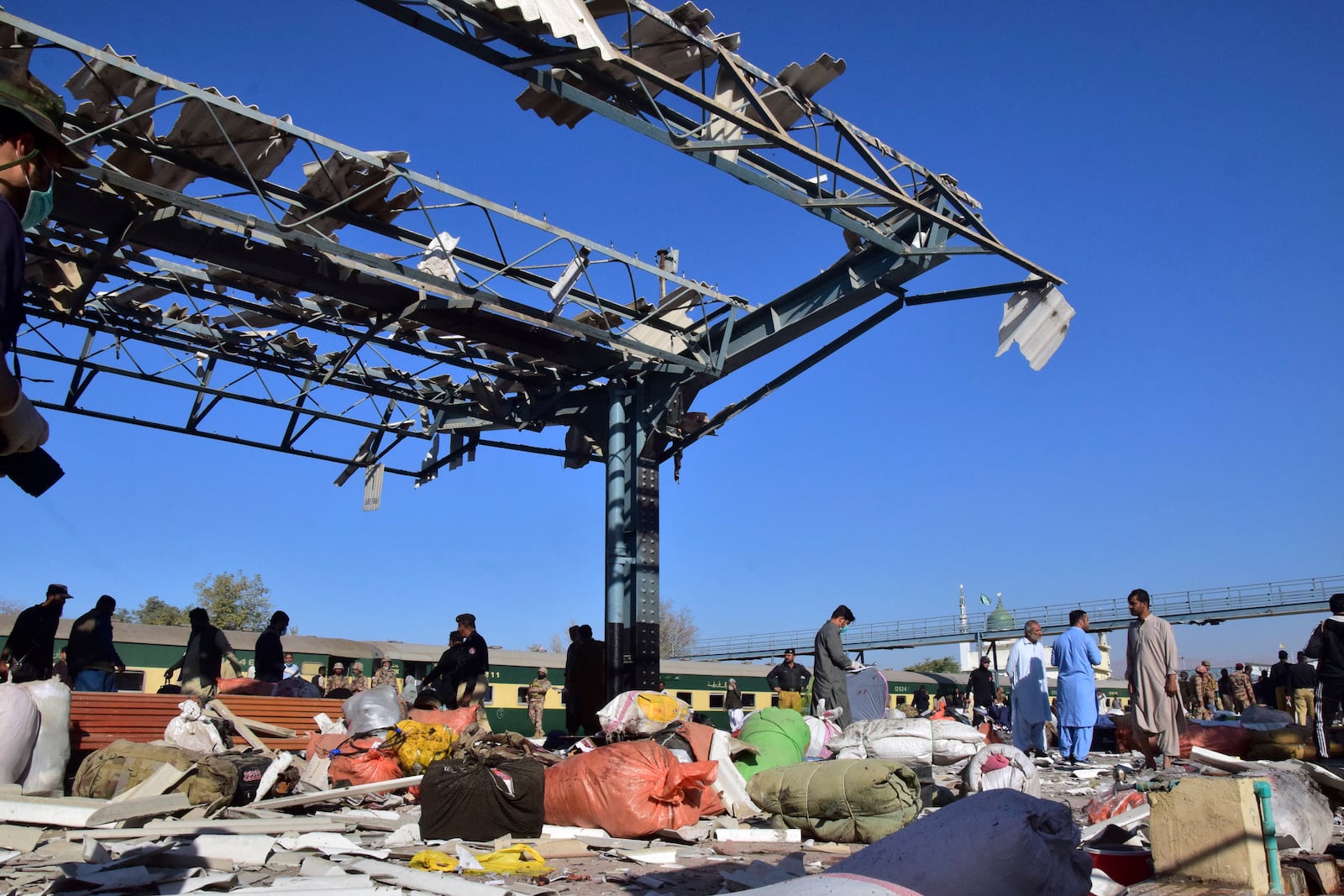 Security officials examine the site of a bomb explosion at railway station in Quetta, southwestern Pakistan, Saturday, Nov. 9, 2024. (AP Photo/Arshad Butt)