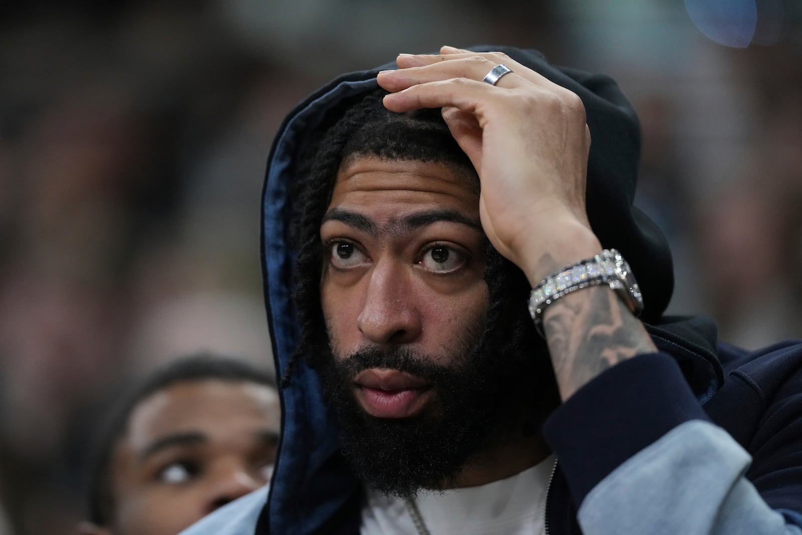 Dallas Mavericks forward Anthony Davis watches from the bench during the second half of an NBA basketball game against the San Antonio Spurs in San Antonio, Monday, March 10, 2025. (AP Photo/Eric Gay)