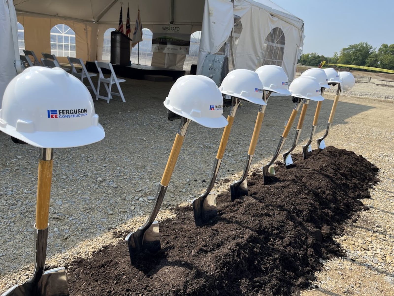 Spades at the ready: A line of spades and Ferguson Construction hard hats were ready for the ceremonial groundbreaking for the Westrafo America transformer production plant off Wolf Creek Pike Monday. THOMAS GNAU/STAFF