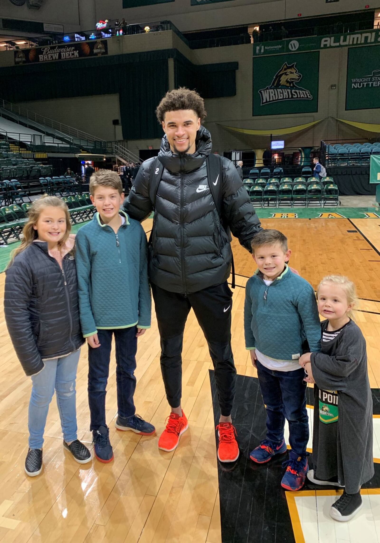 Three-year-old Sloane Burleson (right) and her three cousins (L to R) Juliana, Braden and Bennett, gather around Wright State star Tanner Holden on the Nutter Center court following the Raiders 83-71 victory over Oakland Saturday night. Sloane s dad, Dr. Drew Burleson, was a four-year starter, three- time team captain and scored 1,176 career points for the Raiders from 2003-2007. CONTRIBUTED PHOTO