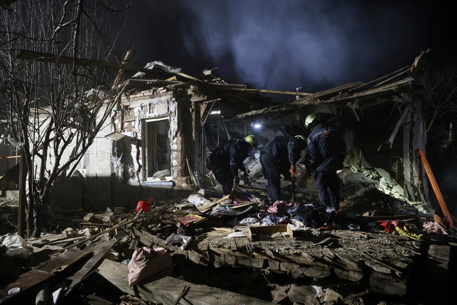 Rescue workers clear the rubble of a residential house destroyed by a Russian drone strike in Zaporizhzhia, Ukraine, Friday, March 21, 2024. (AP Photo/Kateryna Klochko)