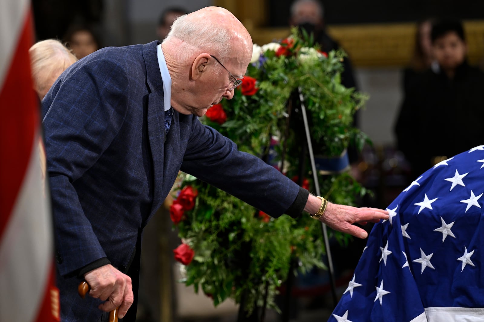 Former Sen. Patrick Leahy of Vermont touches the flag draped casket of the late former President Jimmy Carter as he lies in state at the Rotunda of the U.S. Capitol on Wednesday , Jan. 8, 2025, in Washington. (AP Photo/John McDonnell)