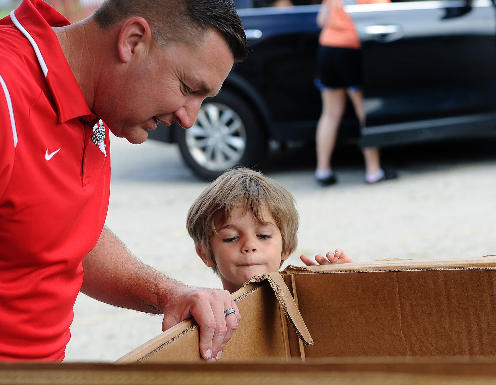 Chad Wyen, Superintendent Mad River Local Schools, helps Brantley Bingamon, age 6, pick out a free backpack Friday, Aug. 25, 2023 at the Overlook Community Center. The school district gave away free backpacks to students. MARSHALL GORBY\STAFF