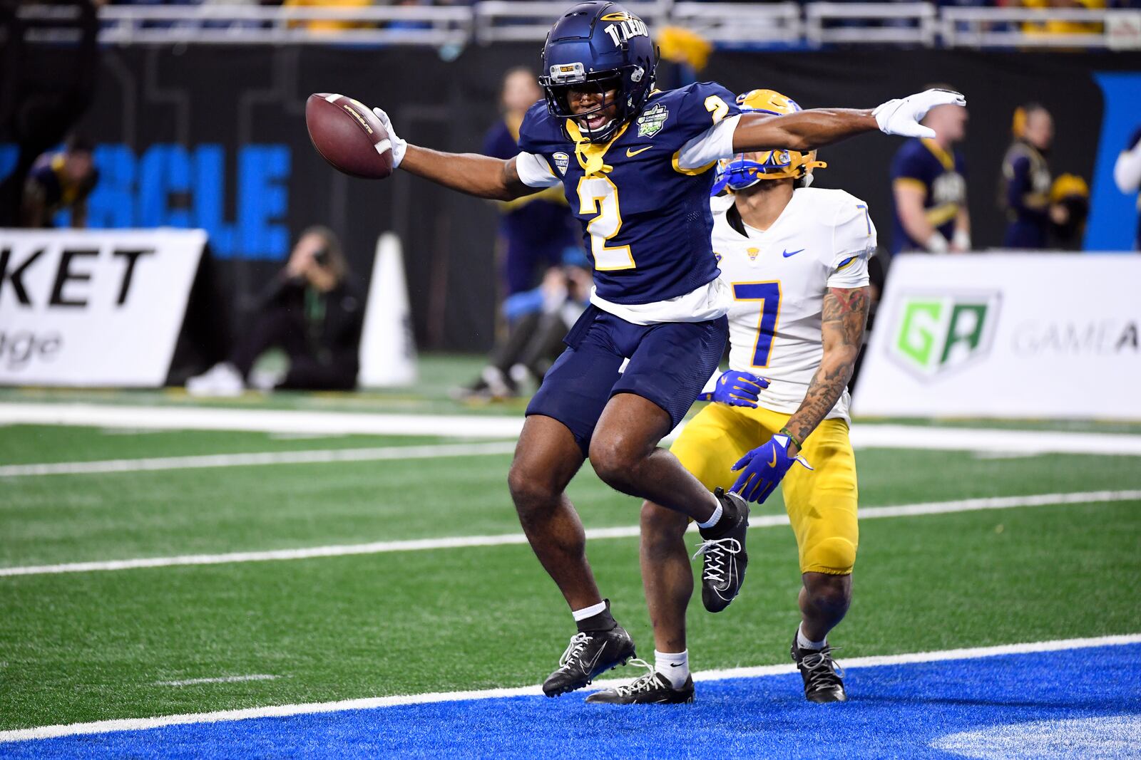 Toledo wide receiver Junior Vandeross III (2) reacts after making a catch for a first down as Pittsburgh defensive back Javon McIntyre, right, looks on during the first half of the GameAbove Sports Bowl NCAA college football game, Thursday, Dec. 26, 2024, in Detroit. (AP Photo/Jose Juarez)